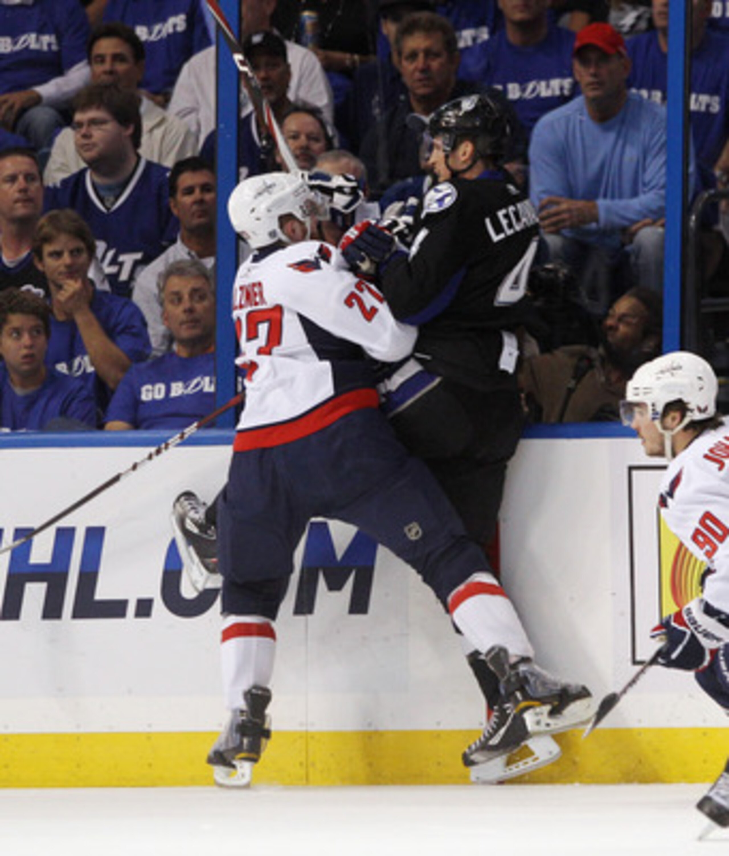 TAMPA, FL - MAY 03: Karl Alzner #27 of the Washington Capitals hits Vincent Lecavalier #4 of the Tampa Bay Lightning into the boards in Game Three of the Eastern Conference Semifinals during the 2011 NHL Stanley Cup Playoffs at St Pete Times Forum on May 