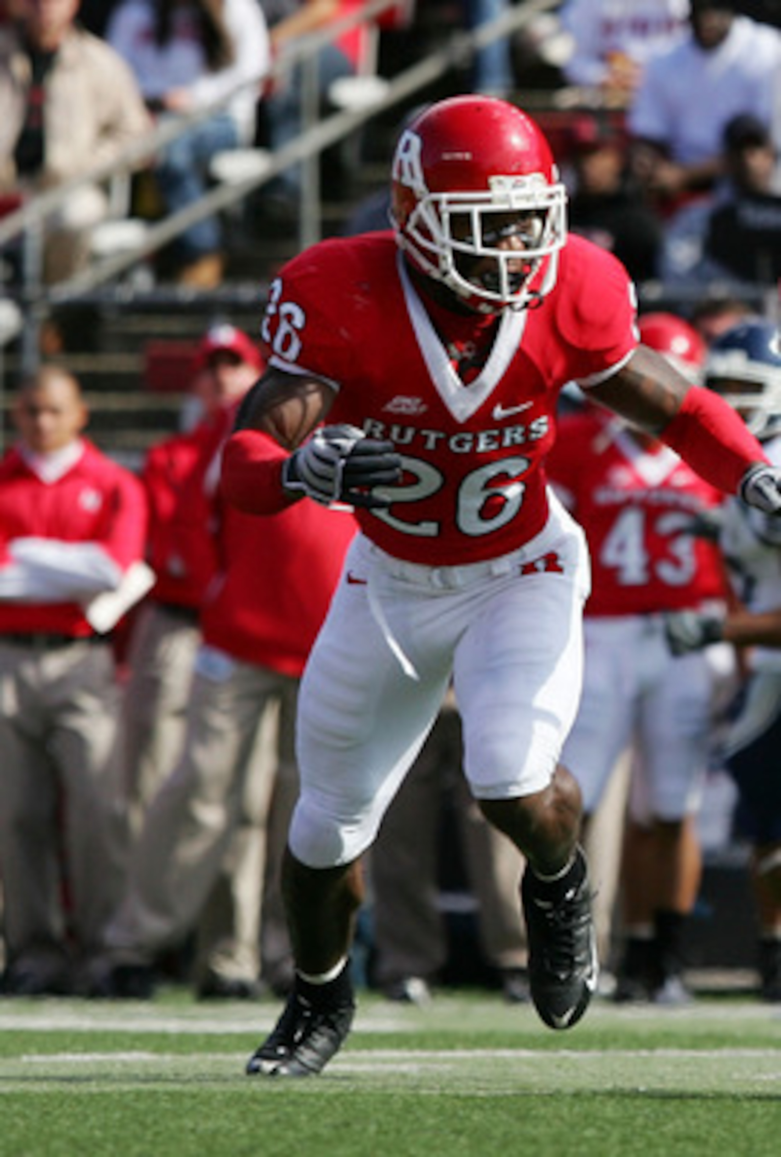 PISCATAWAY, NJ - OCTOBER 18:  Michael Smith #80 of the Connecticut Huskies runs the ball after a reception against Joe Lefeged #26 of the Rutgers Scarlet Knights at Rutgers Stadium on October 18, 2008 in Piscataway, New Jersey.  (Photo by Jim McIsaac/Gett