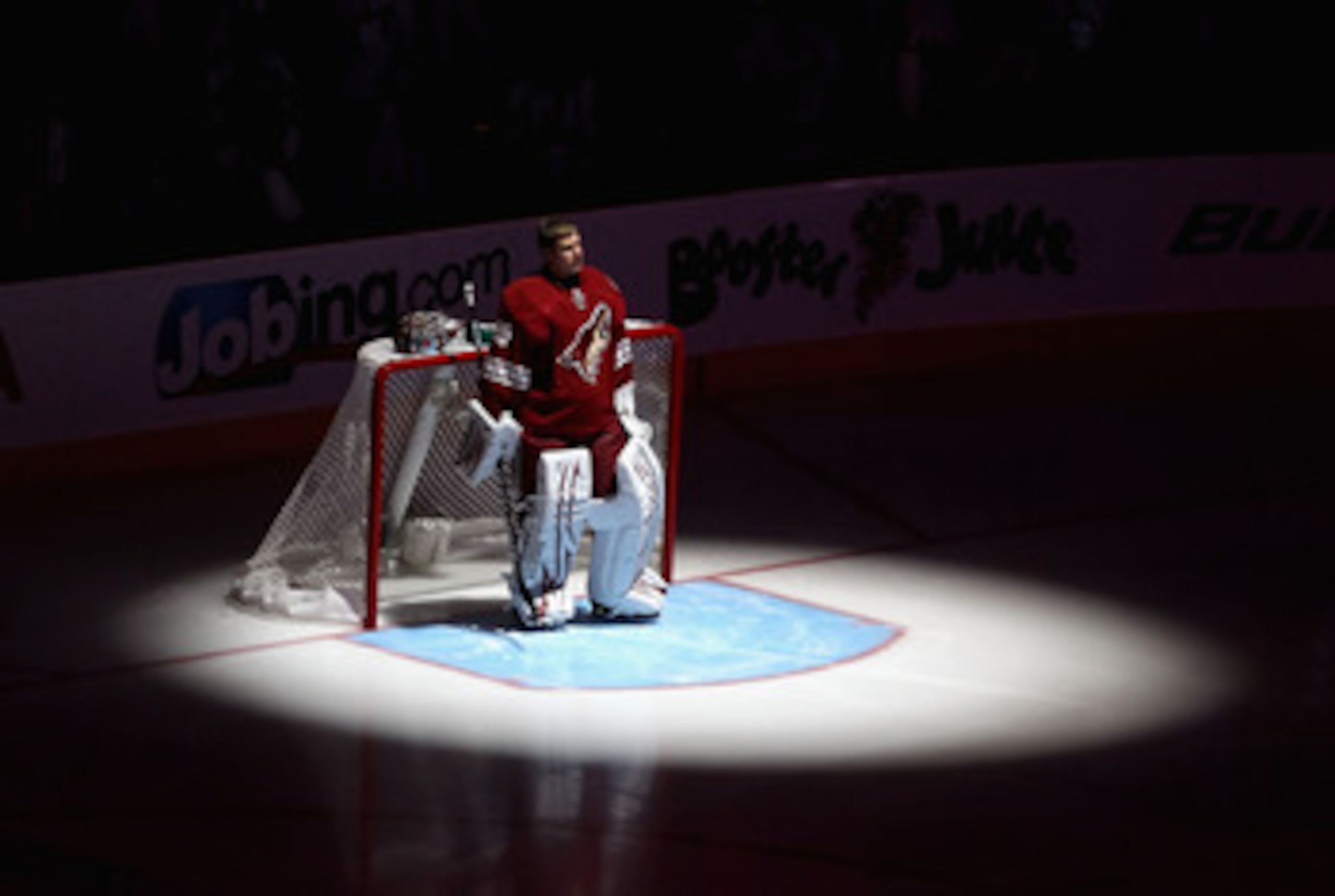 GLENDALE, AZ - APRIL 20:  Goaltender Ilya Bryzgalov #30 of the Phoenix Coyotes stands attended for the National Anthem before Game Four of the Western Conference Quarterfinals against the Detroit Red Wings during the 2011 NHL Stanley Cup Playoffs at Jobin