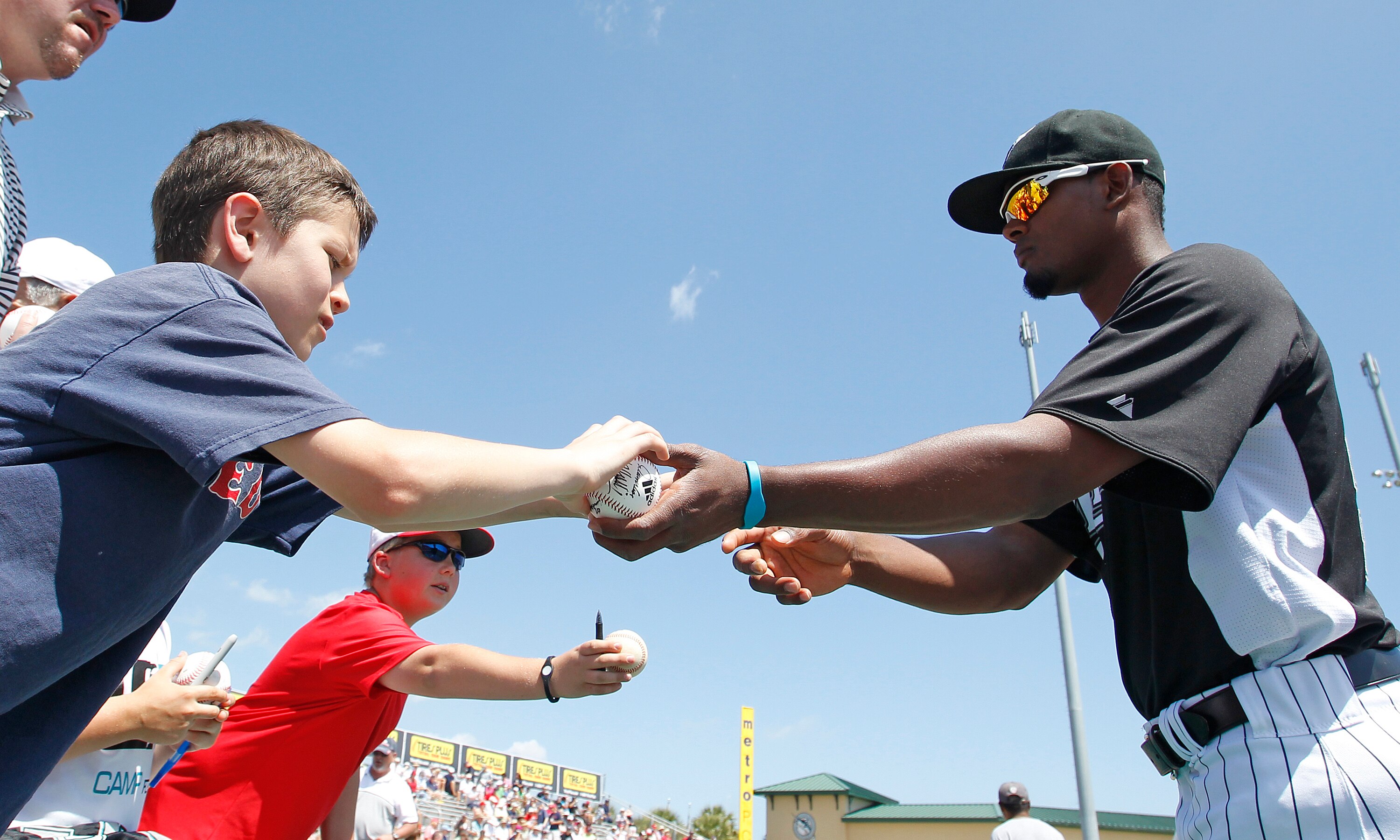 JUPITER, FL - MARCH 24: A young Florida Marlins fan gets an autograph by Jhan Marinez #54 prior to the game against the Boston Red Sox at Roger Dean Stadium on March 24, 2011 in Jupiter, Florida. The Marlins defeated the Red Sox 15-7. (Photo by Joel Auerb