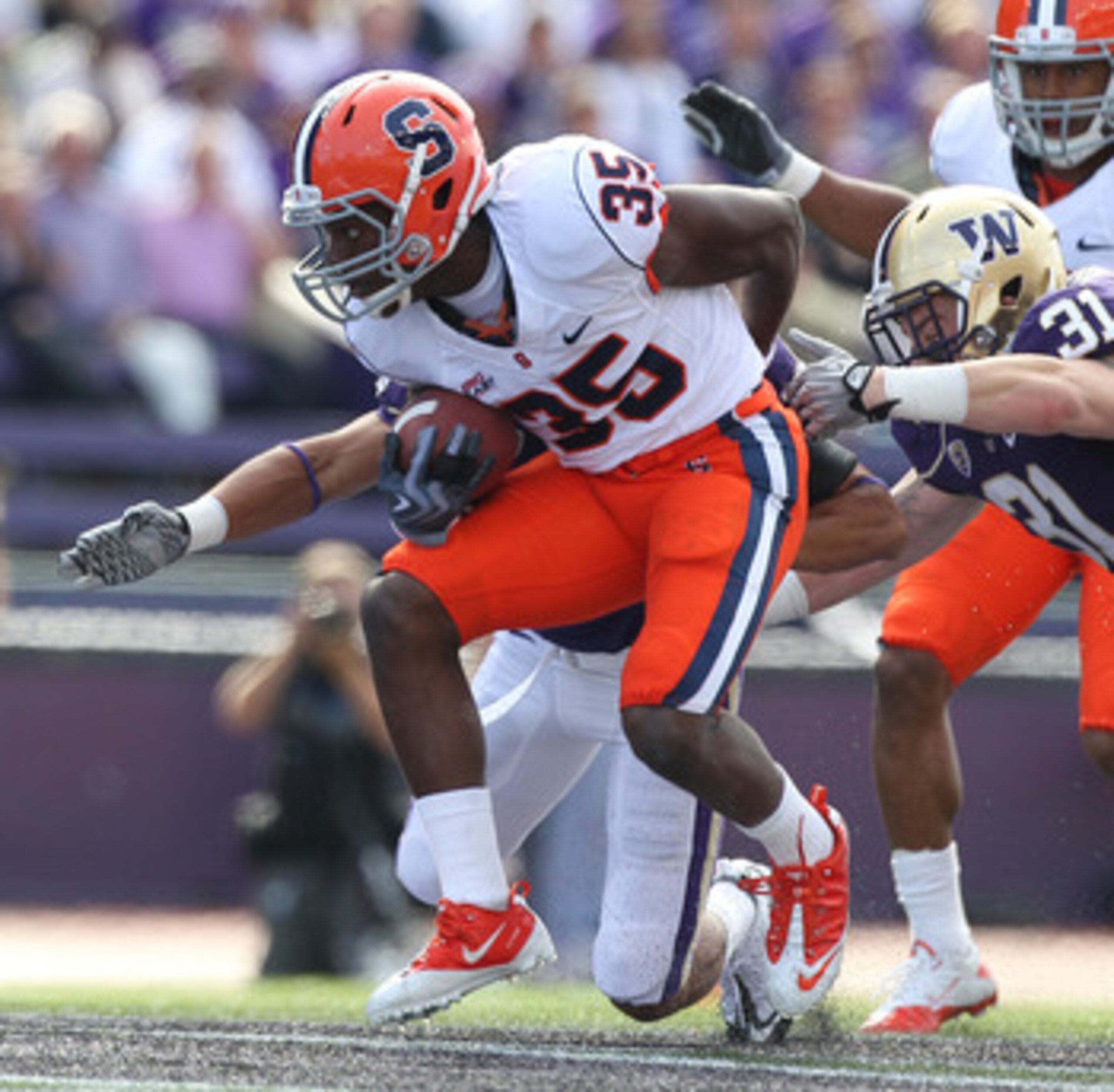 SEATTLE - SEPTEMBER 11:  Mike Holmes #35 of the Syracuse Orange rushes against Cort Dennison #31 of the Washington Huskies on September 11, 2010 at Husky Stadium in Seattle, Washington. (Photo by Otto Greule Jr/Getty Images)