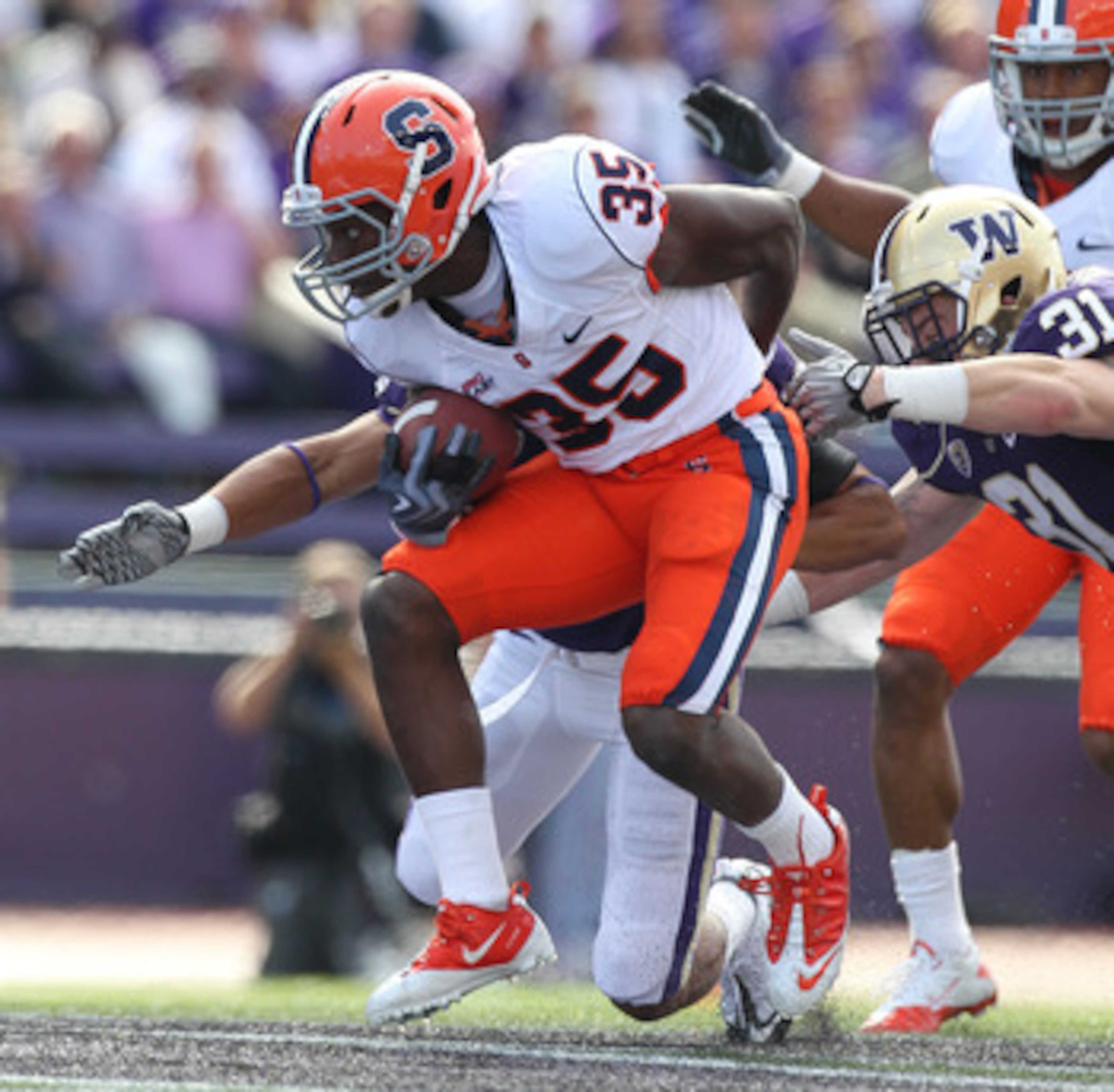 SEATTLE - SEPTEMBER 11:  Mike Holmes #35 of the Syracuse Orange rushes against Cort Dennison #31 of the Washington Huskies on September 11, 2010 at Husky Stadium in Seattle, Washington. (Photo by Otto Greule Jr/Getty Images)