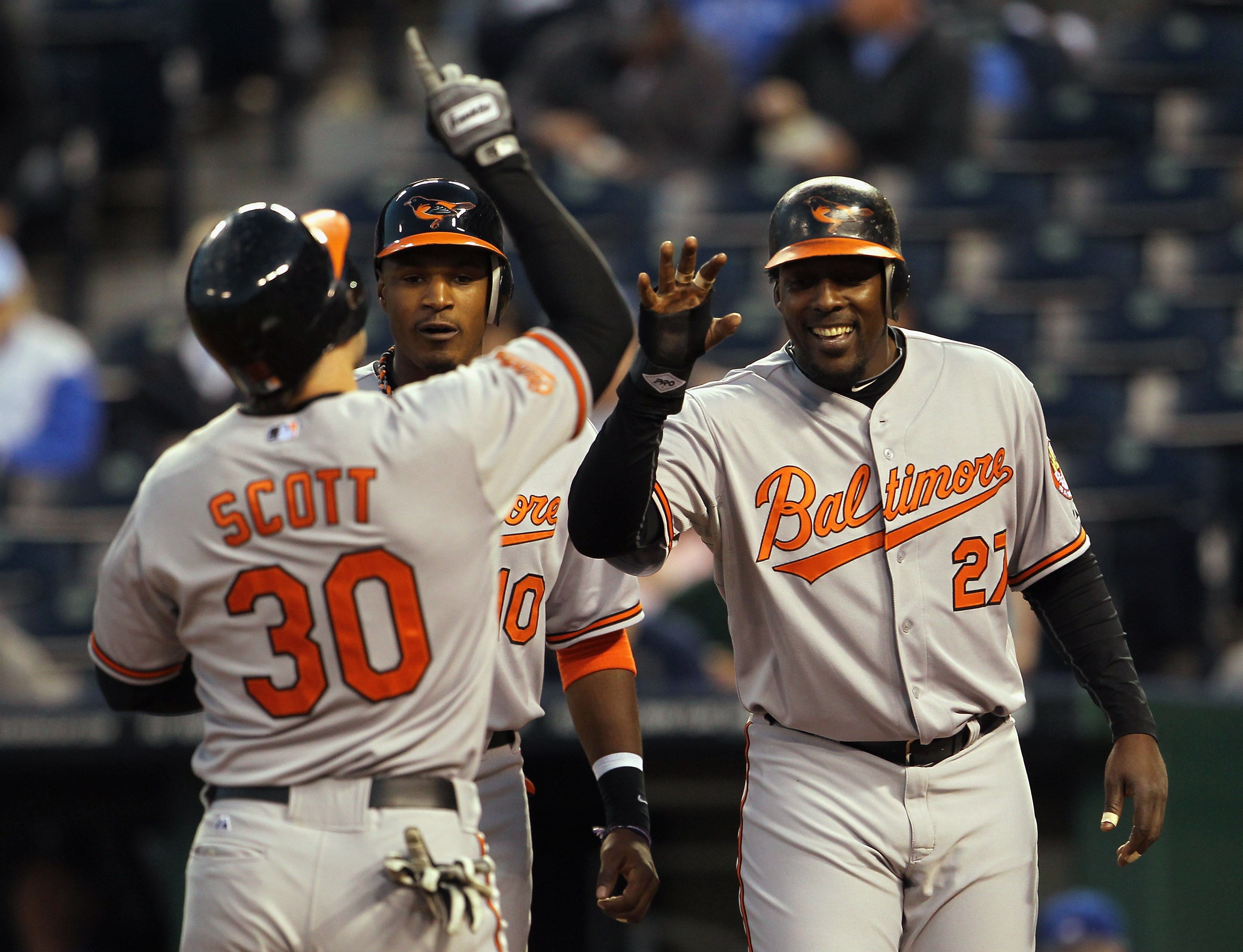 KANSAS CITY, MO - MAY 03:  Luke Scott #30 of the Baltimore Orioles is congratulated by Adam Jones #10 and Vladimir Guerrero #27 after hitting a 3-run home run during the 4th inning of the game against the Kansas City Royals on May 3, 2011 at Kauffman Stad