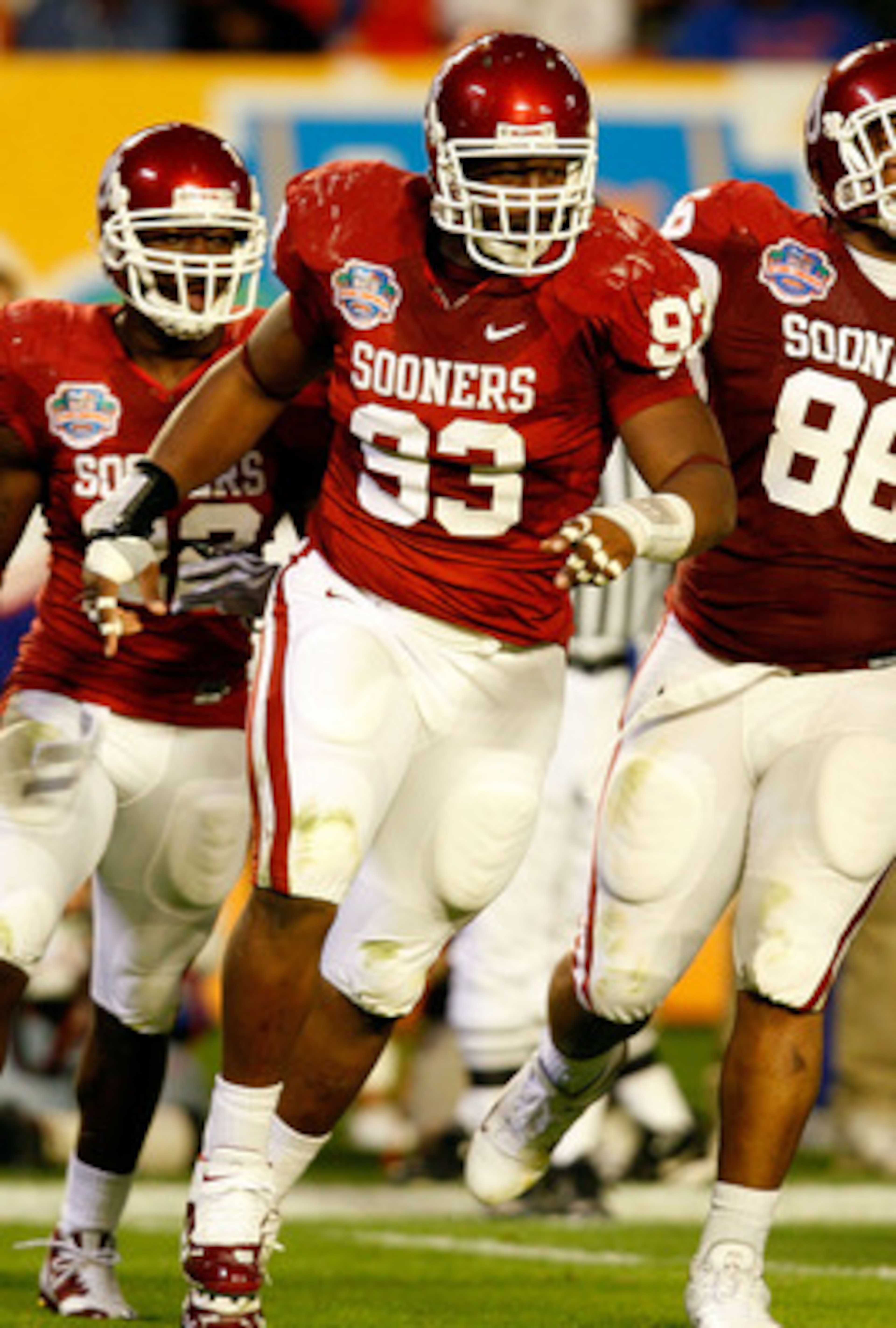 MIAMI - JANUARY 08:  (L-R) Keenan Calhoun #22, Gerald McCoy #93 and Adrian Taylor #86 of the Oklahoma Sooners celebrate a defensive stop against the Florida Gators during the FedEx BCS National Championship game at Dolphin Stadium on January 8, 2009 in Mi