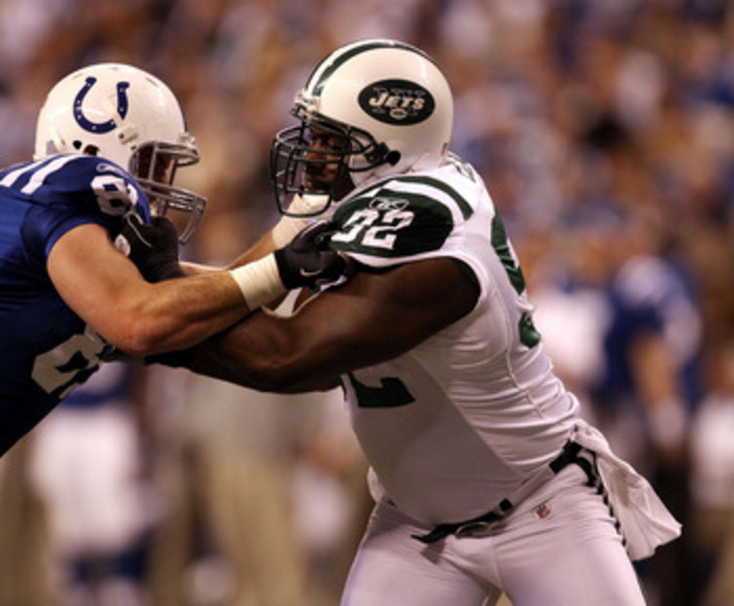 INDIANAPOLIS, IN - JANUARY 08:  Defensive end Shaun Ellis #92 of the New York Jets rushes the passer against Bobby Eldridge #81 of the Indianapolis Colts during their 2011 AFC wild card playoff game at Lucas Oil Stadium on January 8, 2011 in Indianapolis,