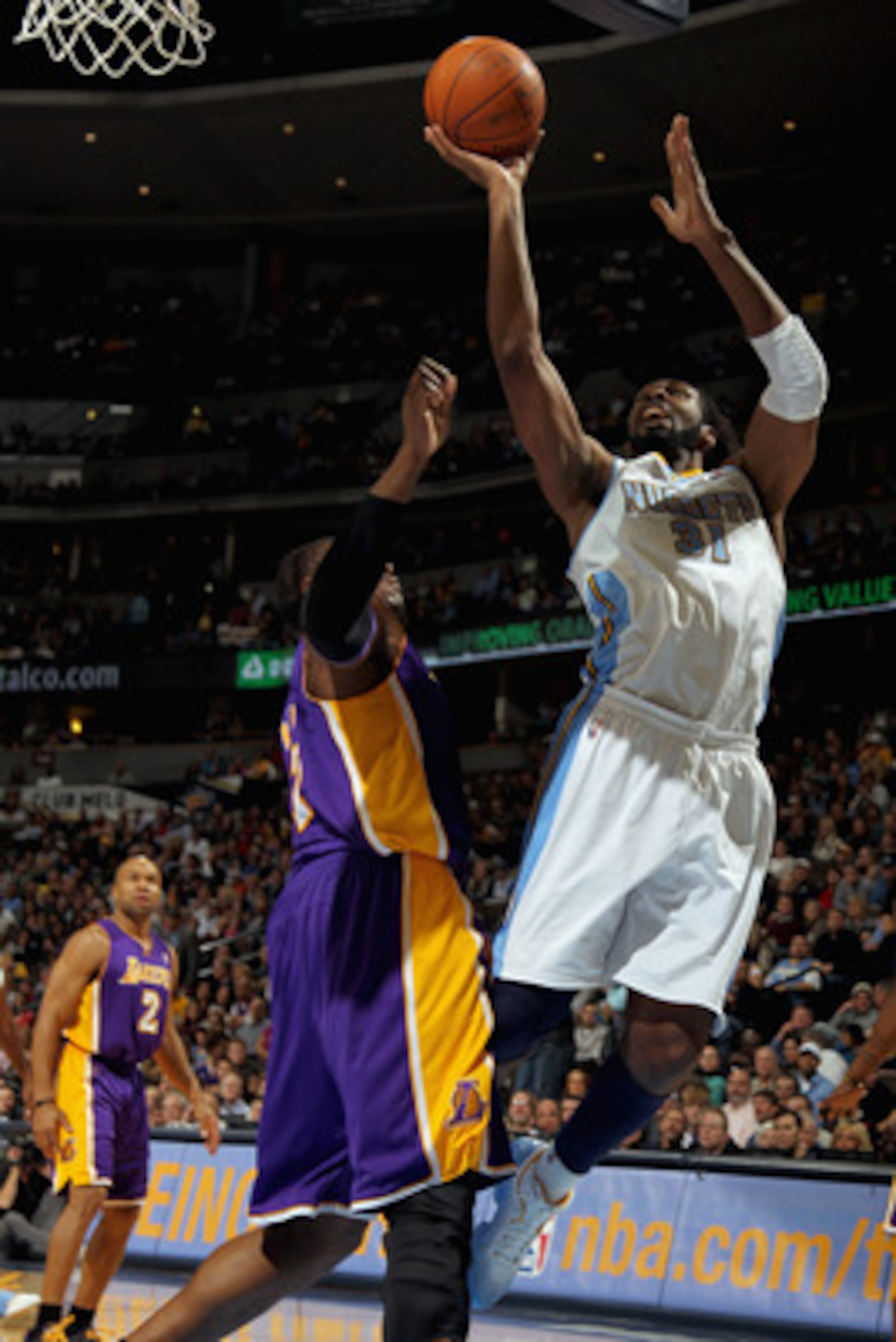 DENVER, CO - JANUARY 21: Nene #31 of the Denver Nuggets puts up a shot against Andrew Bynum #17 of the Los Angeles Lakers at the Pepsi Center on January 21, 2011 in Denver, Colorado. The Lakers defeated the Nuggets 107-97. NOTE TO USER: User expressly ac DENVER, CO - JANUARY 21: Nene #31 of the Denver Nuggets puts up a shot against Andrew Bynum #17 of the Los Angeles Lakers at the Pepsi Center on January 21, 2011 in Denver, Colorado. The Lakers defeated the Nuggets 107-97. NOTE TO USER: User expressly ac