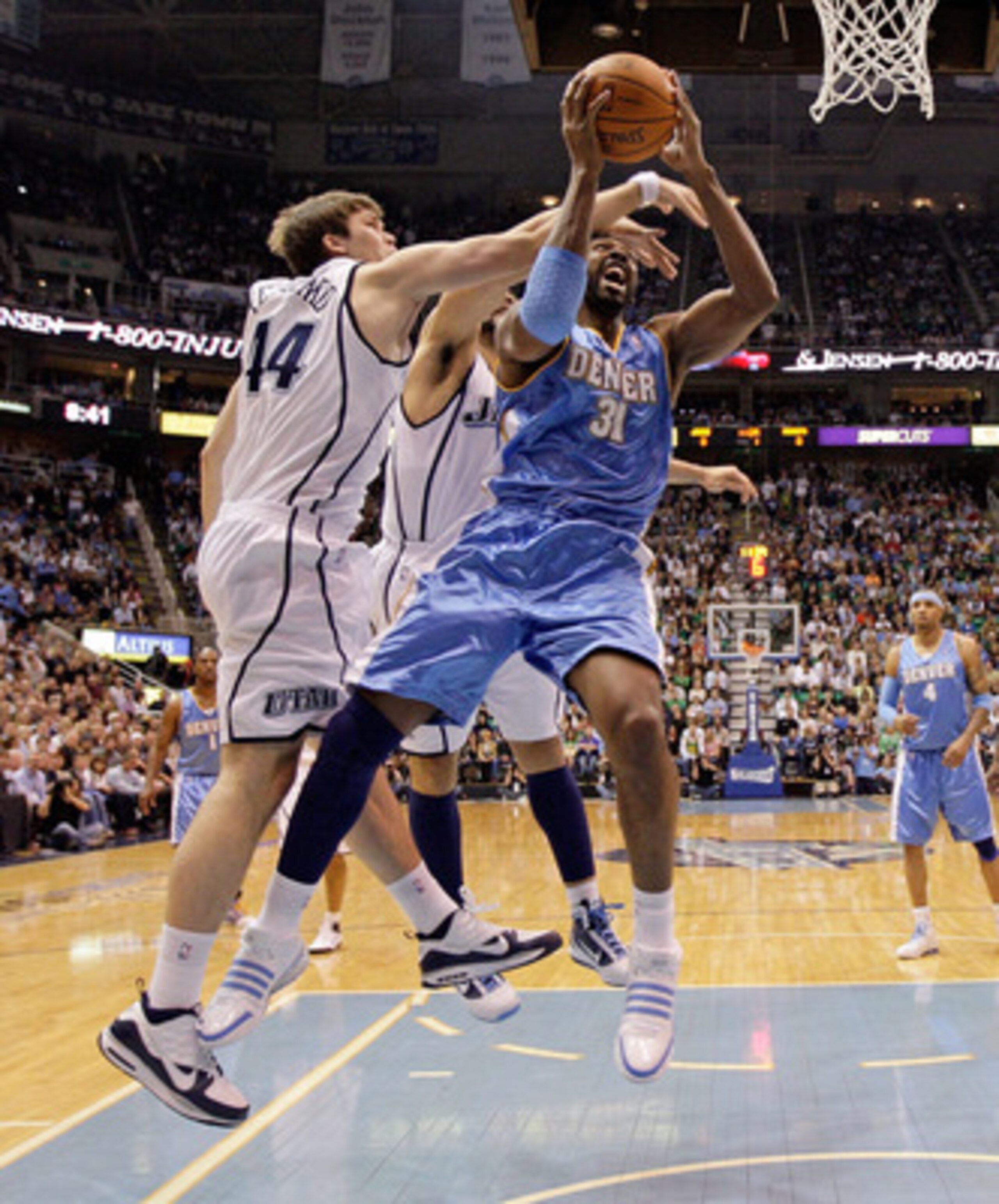 SALT LAKE CITY - APRIL 23: Nene #31 of the Denver Nuggets shoots the ball while defended by Kyrylo Fesenko #44 of the Utah Jazz during  Game 3 of the Western Conference Quarterfinals of the 2010 NBA Playoffs at EnergySolutions Arena on April 23, 2010 in S