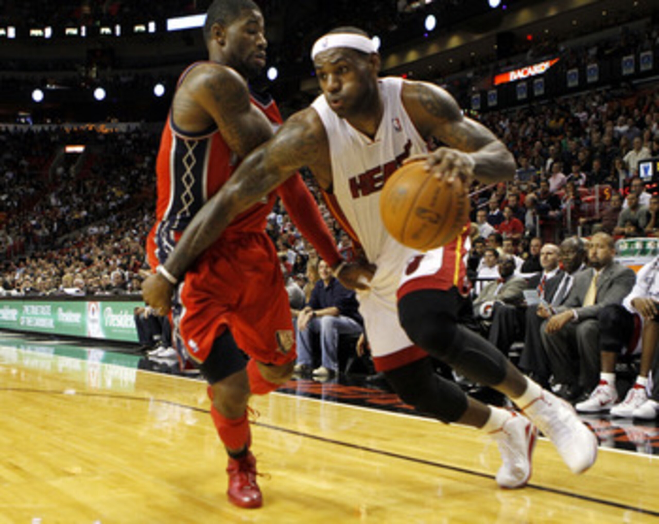 MIAMI - NOVEMBER 06: Forward LeBron James #6 of the Miami Heat drives against guard Terrence Williams #1 of the New Jersey Nets at American Airlines Arena on November 6, 2010 in Miami, Florida. NOTE TO USER: User expressly acknowledges and agrees that, MIAMI - NOVEMBER 06: Forward LeBron James #6 of the Miami Heat drives against guard Terrence Williams #1 of the New Jersey Nets at American Airlines Arena on November 6, 2010 in Miami, Florida. NOTE TO USER: User expressly acknowledges and agrees that,