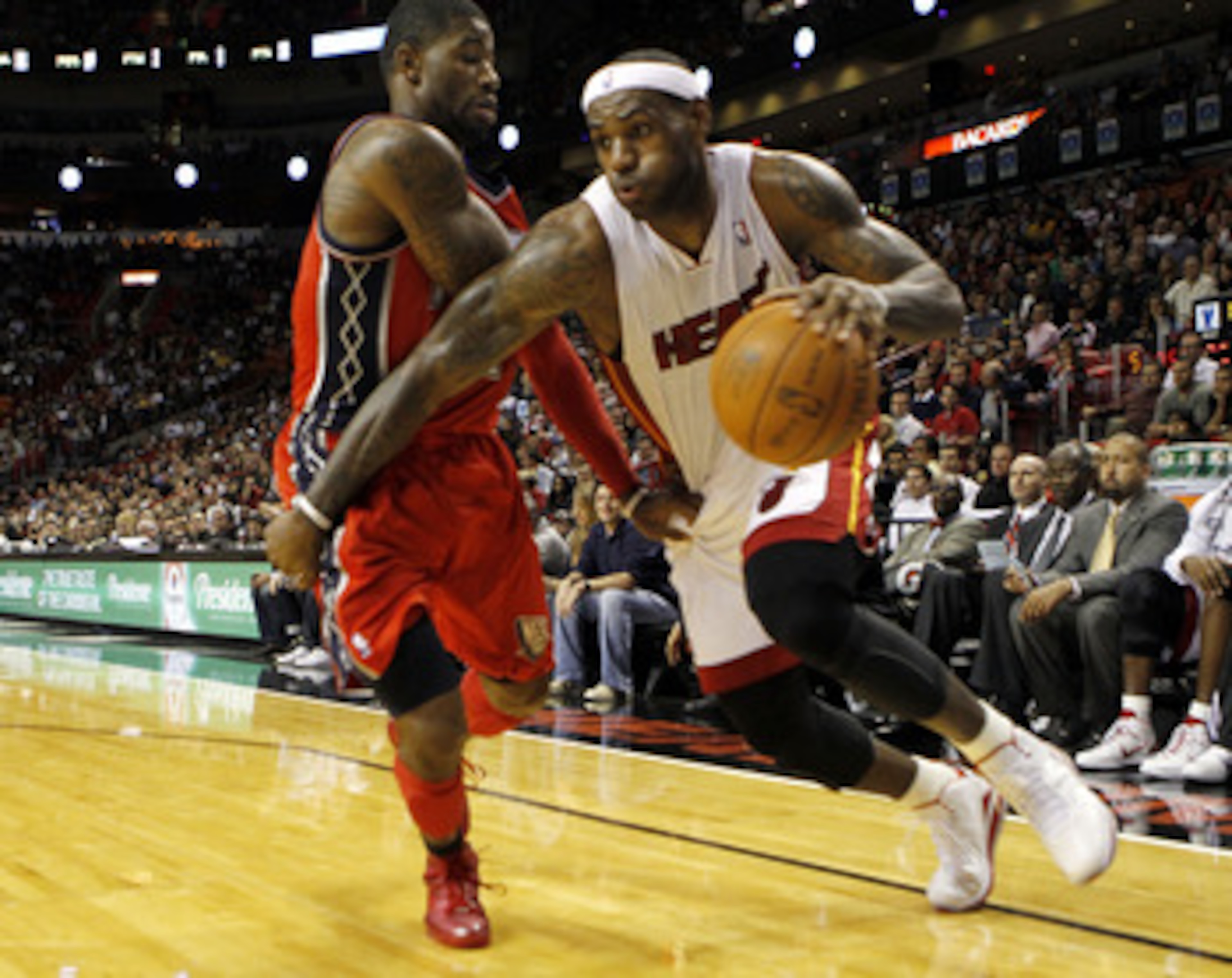 MIAMI - NOVEMBER 06:  Forward LeBron James #6 of the Miami Heat drives against guard Terrence Williams #1 of the New Jersey Nets  at American Airlines Arena on November 6, 2010 in Miami, Florida. NOTE TO USER: User expressly acknowledges and agrees that,