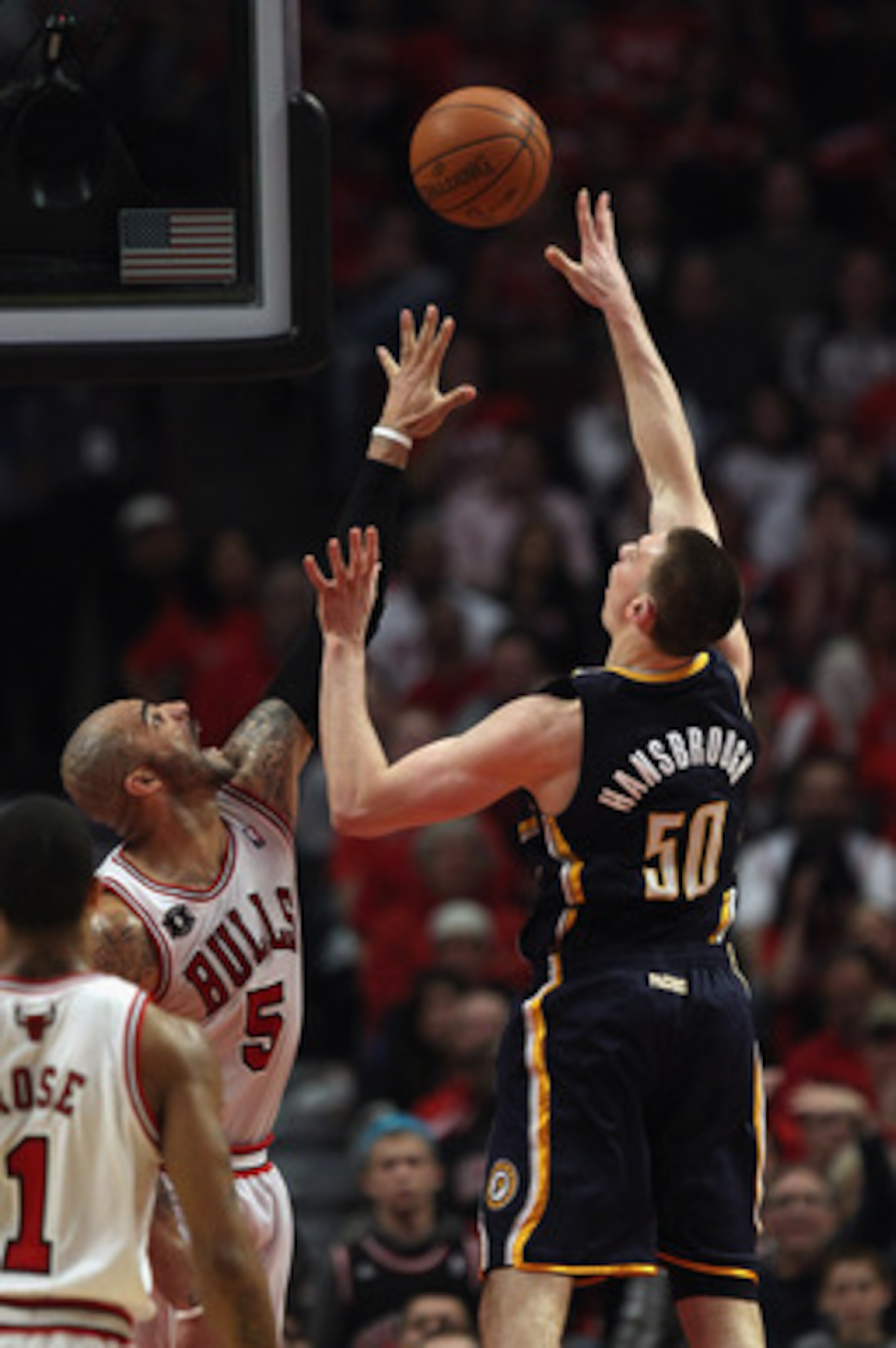 CHICAGO, IL - APRIL 16: Tyler Hansbrough #50 of the Indiana Pacers puts up a shot over Carlos Boozer #5 of the Chicago Bulls in Game One of the Eastern Conference Quarterfinals in the 2011 NBA Playoffs at the United Center on April 16, 2011 in Chicago, Il
