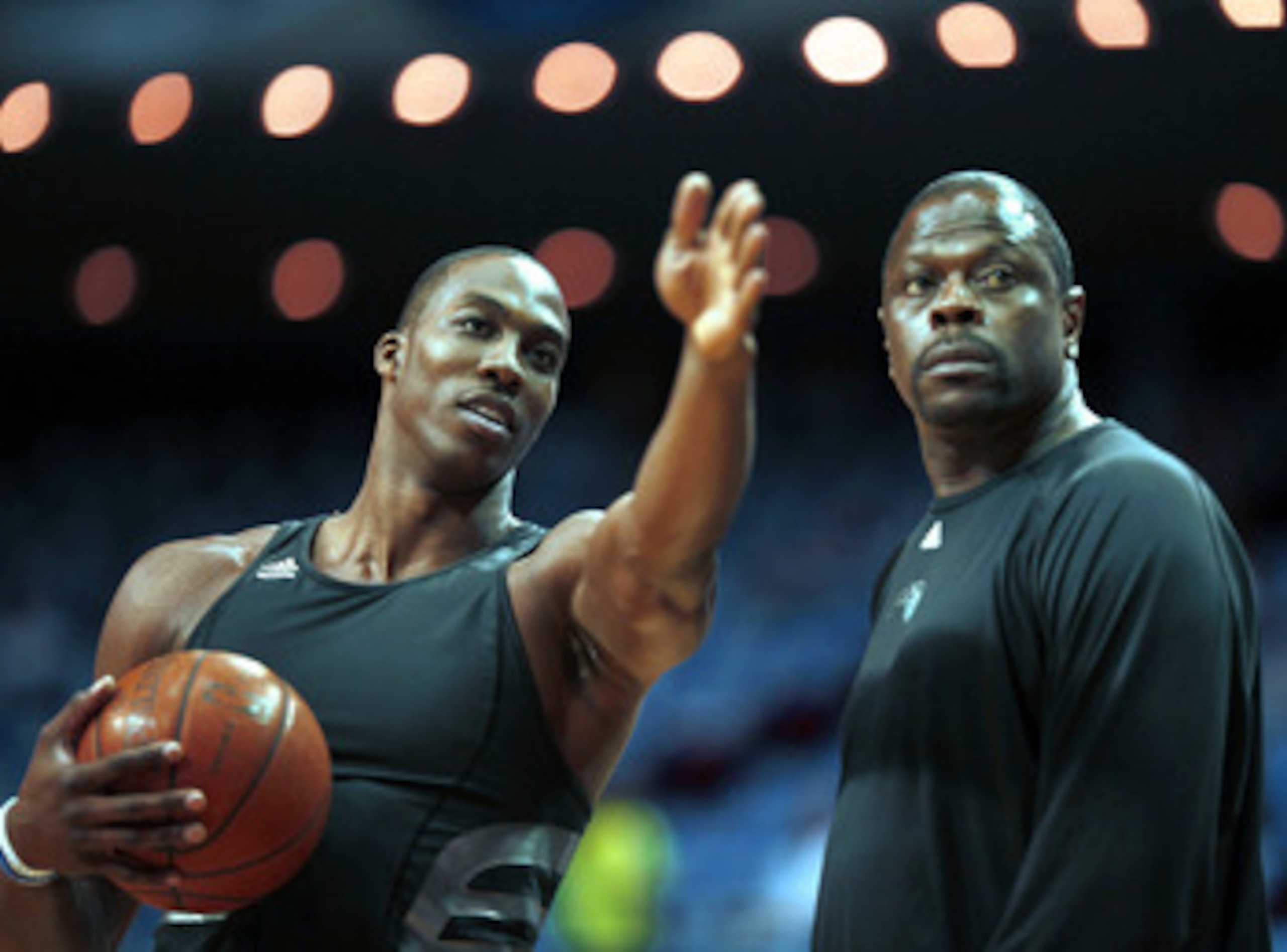 ORLANDO, FL - MAY 08:  Dwight Howard #12 of the Orlando Magic (L) chats with assistant coach Patrick Ewing prior to playing the Boston Celtics in Game three of the Eastern Conference Semifinals during the 2009 NBA Playoffs at at Amway Arena on May 8, 2009