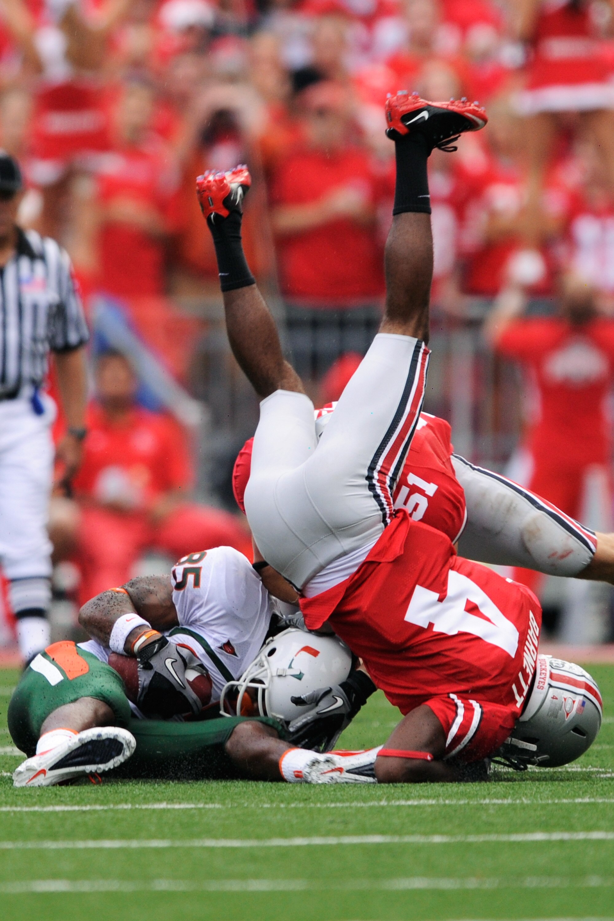 COLUMBUS, OH - SEPTEMBER 11:  Leonard Hankerson #85 of the Miami Hurricanes is crushed by C.J. Barnett #4 of the Ohio State Buckeyes after a reception at Ohio Stadium on September 11, 2010 in Columbus, Ohio.  (Photo by Jamie Sabau/Getty Images)