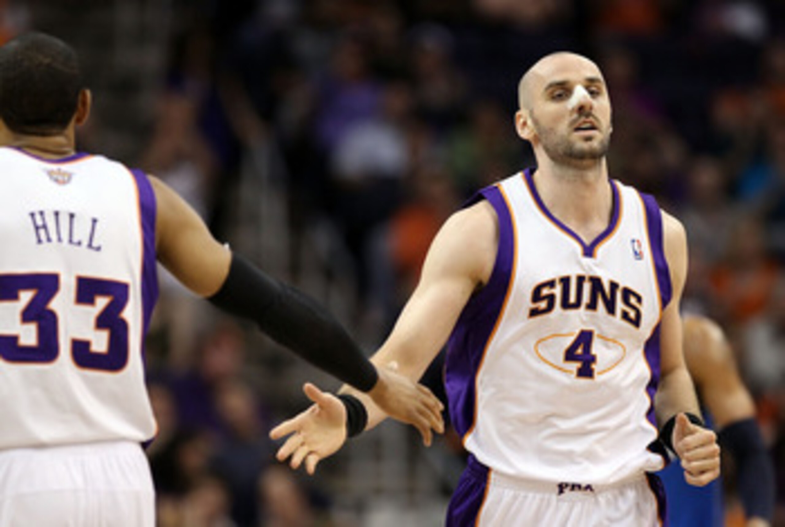 PHOENIX, AZ - MARCH 27: Marcin Gortat #4 of the Phoenix Suns high fives teammate Grant Hill #33 after scoring against the Dallas Mavericks during the NBA game at US Airways Center on March 27, 2011 in Phoenix, Arizona. NOTE TO USER: User expressly ackno PHOENIX, AZ - MARCH 27: Marcin Gortat #4 of the Phoenix Suns high fives teammate Grant Hill #33 after scoring against the Dallas Mavericks during the NBA game at US Airways Center on March 27, 2011 in Phoenix, Arizona. NOTE TO USER: User expressly ackno