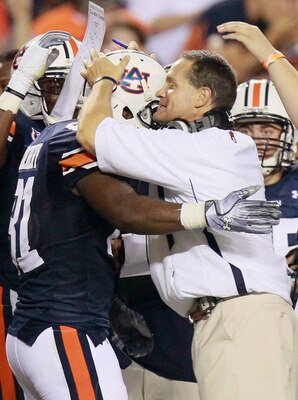 AUBURN, AL - SEPTEMBER 18:  Head coach Gene Chizik of the Auburn Tigers hugs Terrell Zachery #81 after Zachery's touchdown against the Clemson Tigers at Jordan-Hare Stadium on September 18, 2010 in Auburn, Alabama.  (Photo by Kevin C. Cox/Getty Images)