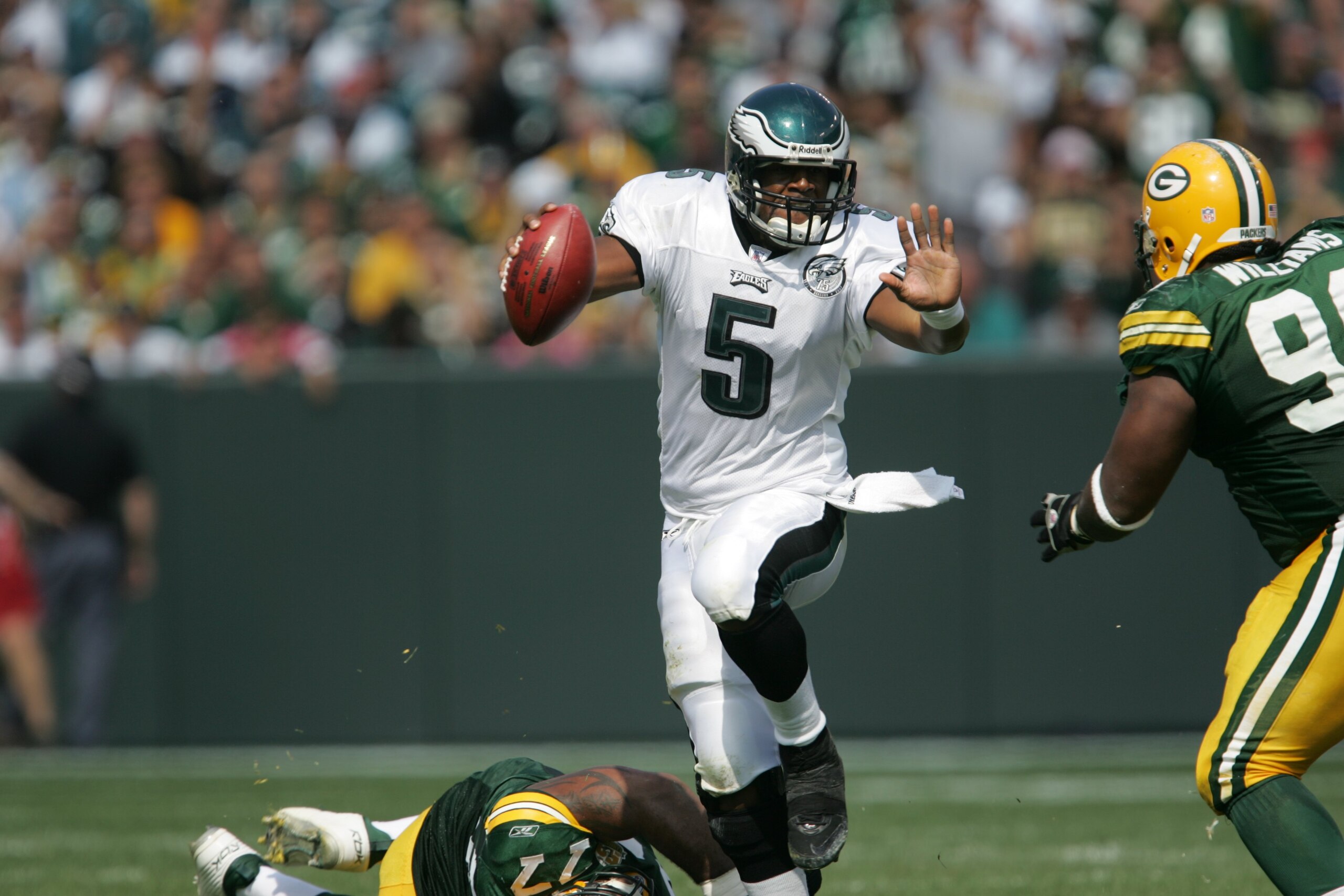 GREEN BAY, WI - SEPTEMBER 09: Donovon McNabb #5 of the Philadelphia Eagles gets away from Cullen Jenkins #77 of the Green Bay Packers while looking for a receiver on September 9, 2007 at Lambeau Field in Green Bay, Wisconsin. The Packers defeated the Eagl