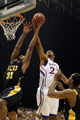 SAN ANTONIO, TX - MARCH 27:  Marcus Morris #22 of the Kansas Jayhawks grabs the rebound against Toby Veal #31 of the Virginia Commonwealth Rams during the southwest regional final of the 2011 NCAA men's basketball tournament at the Alamodome on March 27,