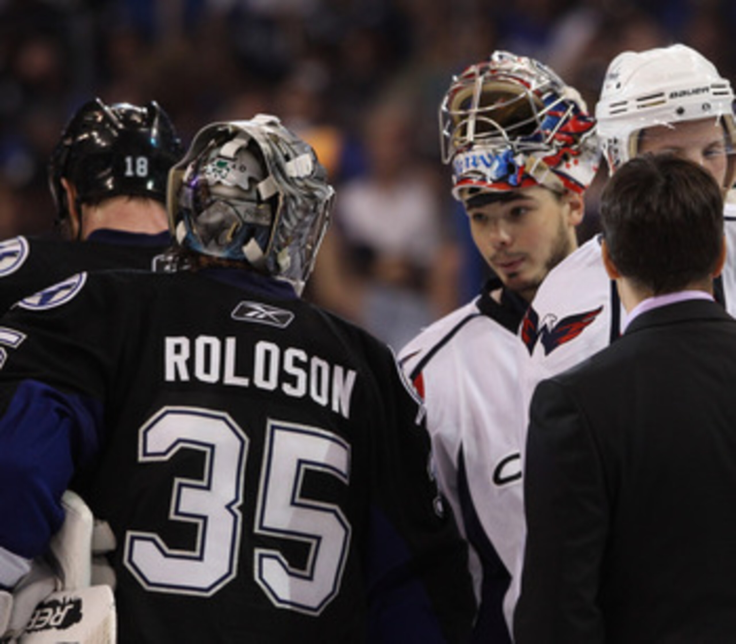 TAMPA, FL - MAY 04: Michal Neuvirth #30 of the Washington Capitals shakes hands with Dwayne Roloson #35 of the Tampa Bay Lightning after Game Four of the Eastern Conference Semifinals during the 2011 NHL Stanley Cup Playoffs at the St Pete Times Forum on 