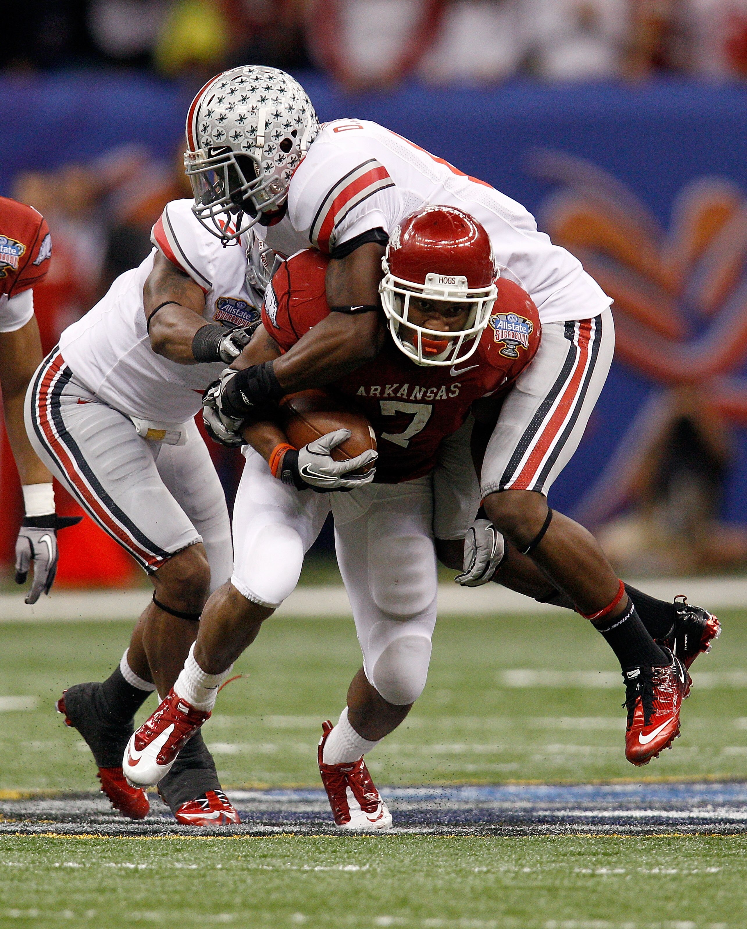 NEW ORLEANS, LA - JANUARY 04:  Knile Davis #7 of the Arkansas Razorbacks runs the ball as Orhian Johnson #19 of the Ohio State Buckeyes attempts to tackle him in the second quarter during the Allstate Sugar Bowl at the Louisiana Superdome on January 4, 20