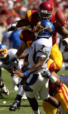 LOS ANGELES - SEPTEMBER 5: Quarterback Kyle Reed #7 of the San Jose State Spartans is hit as he releases a pass by defensive end Nick Perry #8 and defensive tackle Derek Simmons #90 on September 5, 2009 at the Los Angeles Coliseum in Los Angeles, Californ