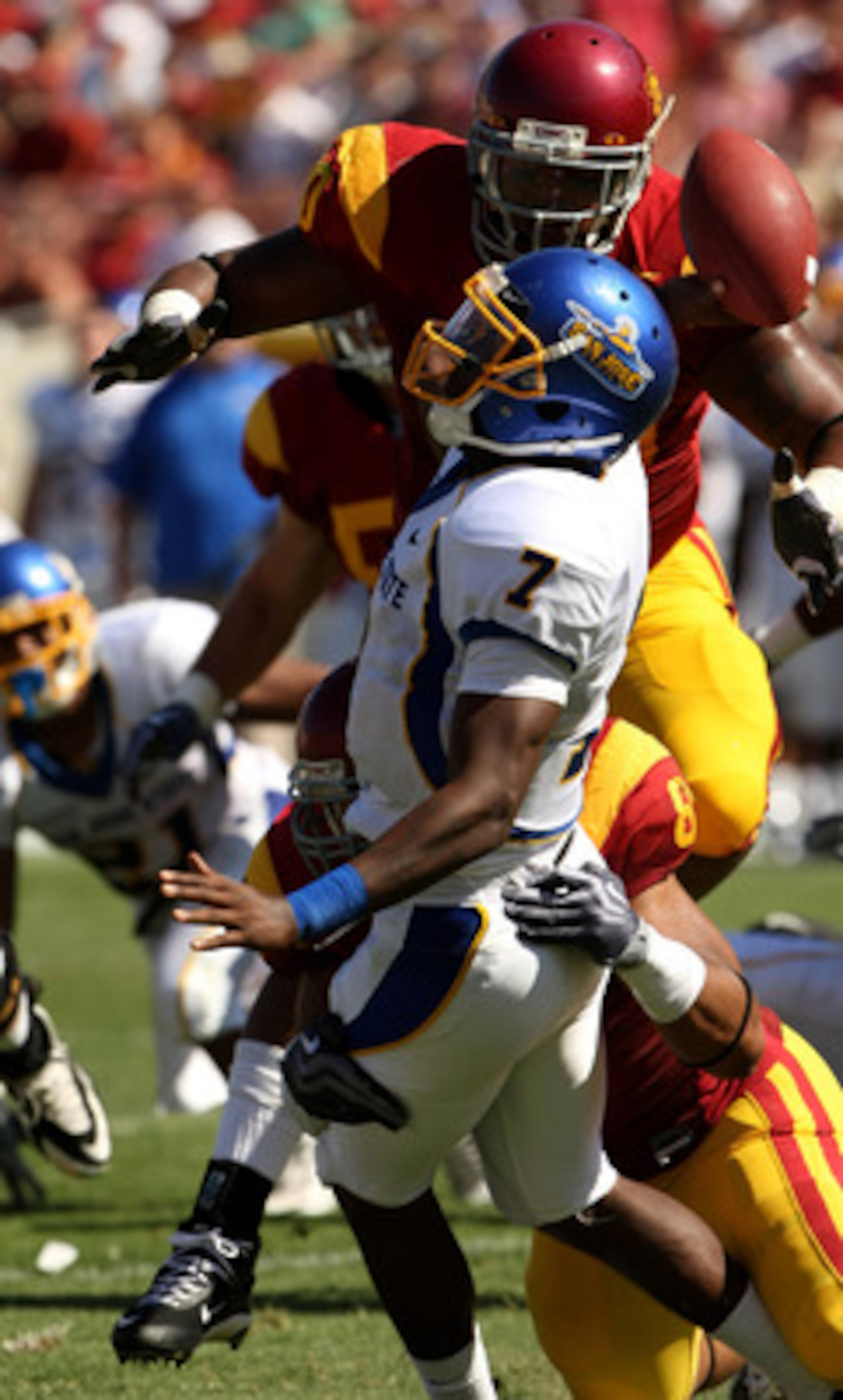 LOS ANGELES - SEPTEMBER 5: Quarterback Kyle Reed #7 of the San Jose State Spartans is hit as he releases a pass by defensive end Nick Perry #8 and defensive tackle Derek Simmons #90 on September 5, 2009 at the Los Angeles Coliseum in Los Angeles, Californ
