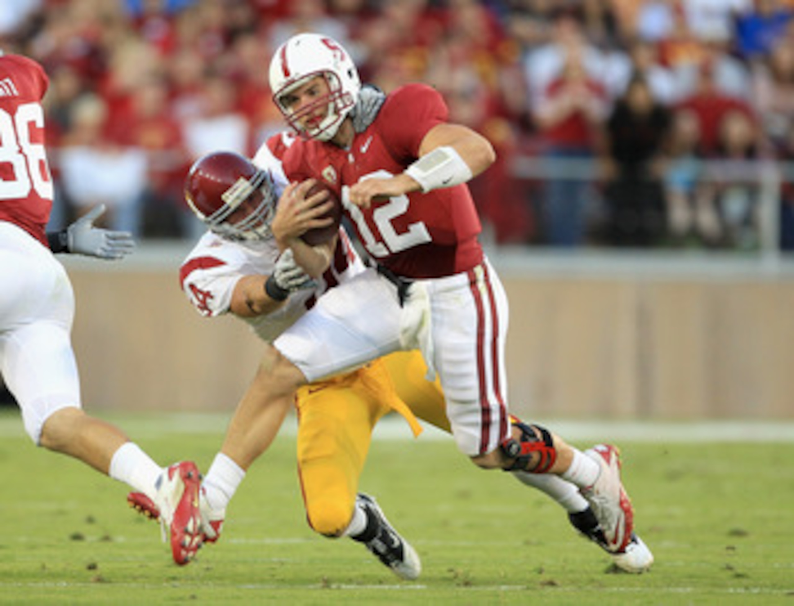 PALO ALTO, CA - OCTOBER 09:  Andrew Luck #12 of the Stanford Cardinal is tackled by Chris Galippo #54 of the USC Trojans at Stanford Stadium on October 9, 2010 in Palo Alto, California.  (Photo by Ezra Shaw/Getty Images)