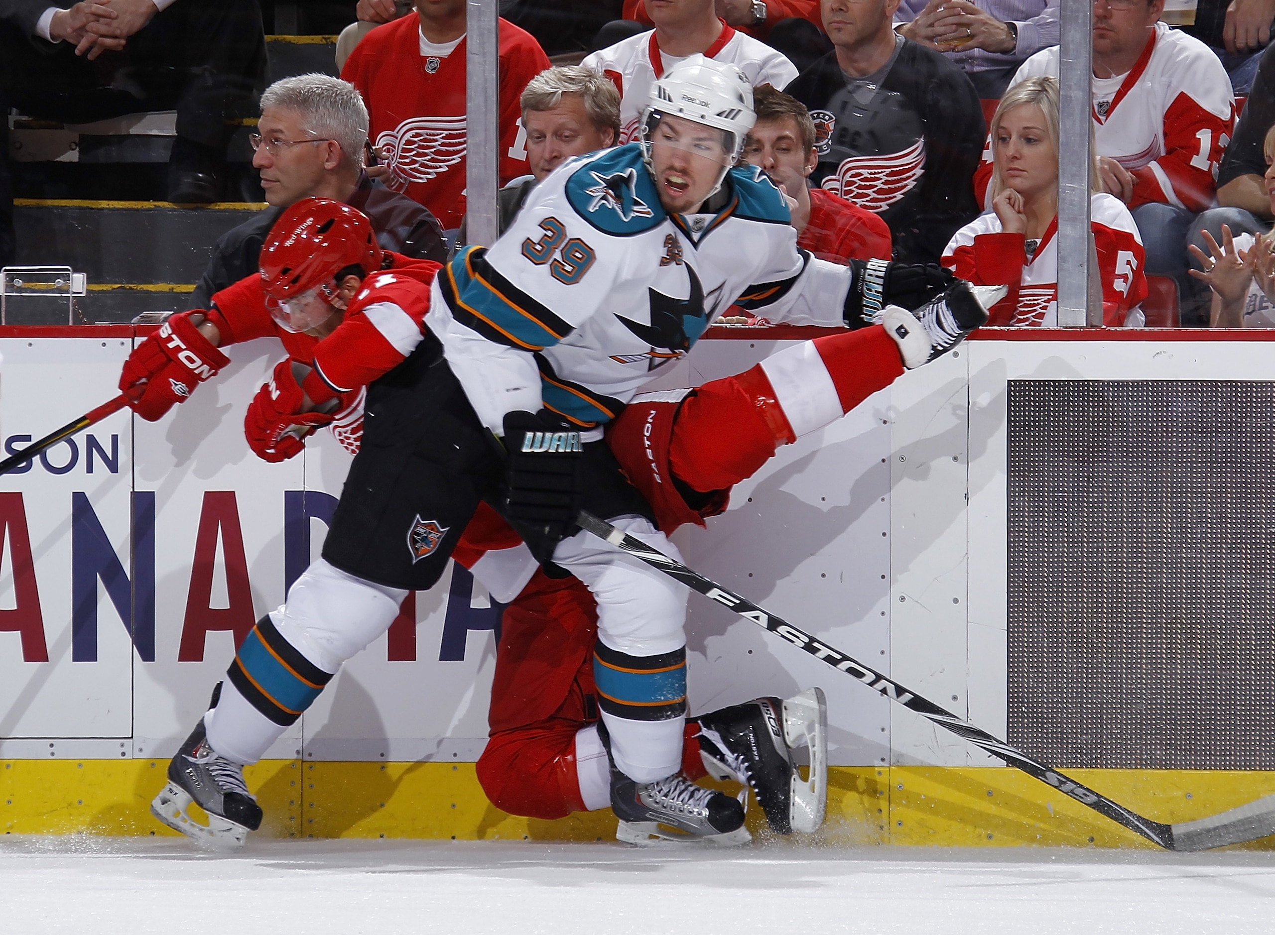 DETROIT - MAY 10: Logan Couture #39 of the San Jose Sharks checks Daniel Cleary #11 of the Detroit Red Wings into the boards during the first period in Game Six of the Western Conference Semifinals during the 2011 NHL Stanley Cup Playoffs on May 10, 2011