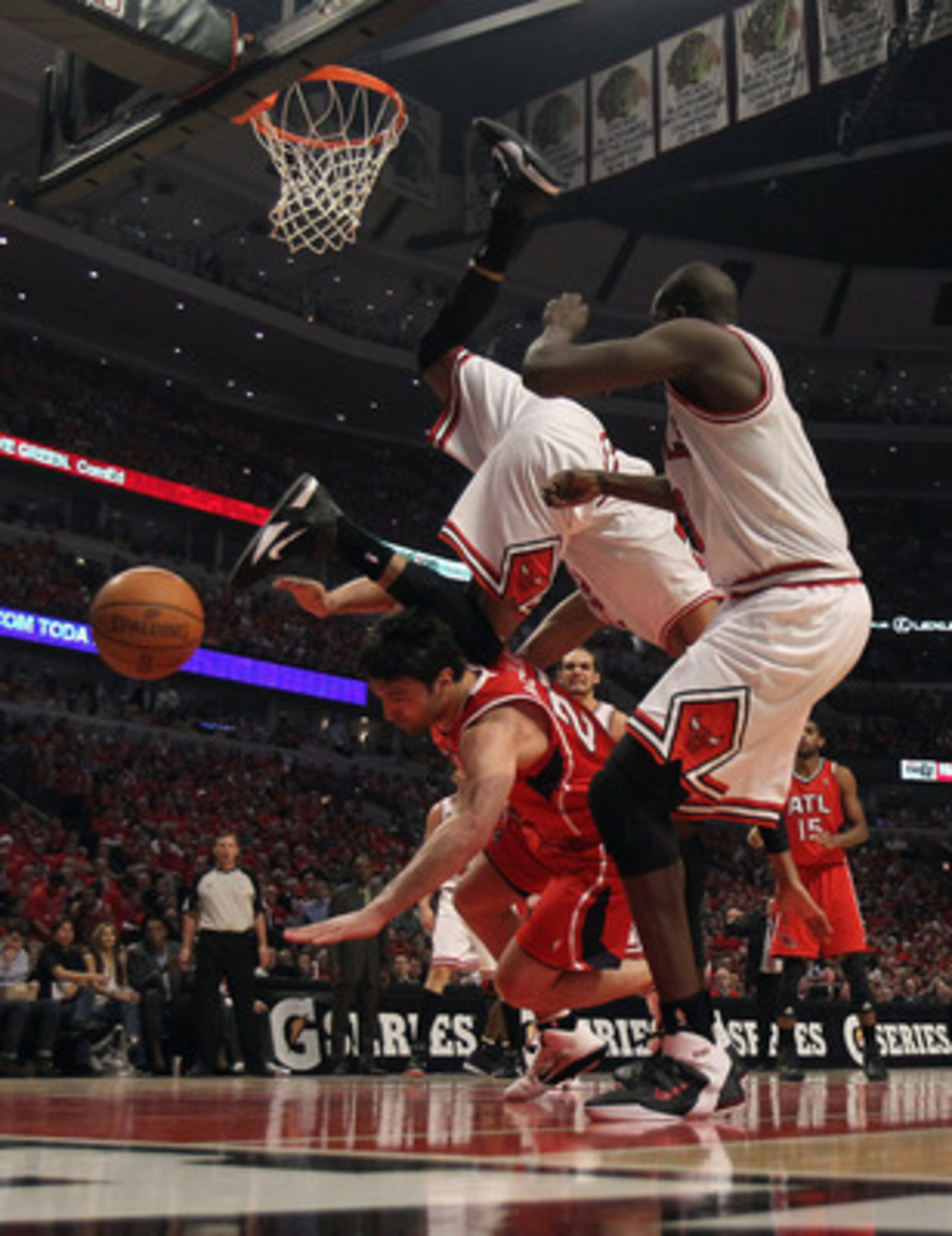 CHICAGO, IL - MAY 10: Taj Gibson #22 of the Chicago Bulls falls over Zaza Pachulia #27 of the Atlanta Hawks in Game Five of the Eastern Conference Semifinals in the 2011 NBA Playoffs at the United Center on May 10, 2011 in Chicago, Illinois. NOTE TO USER: