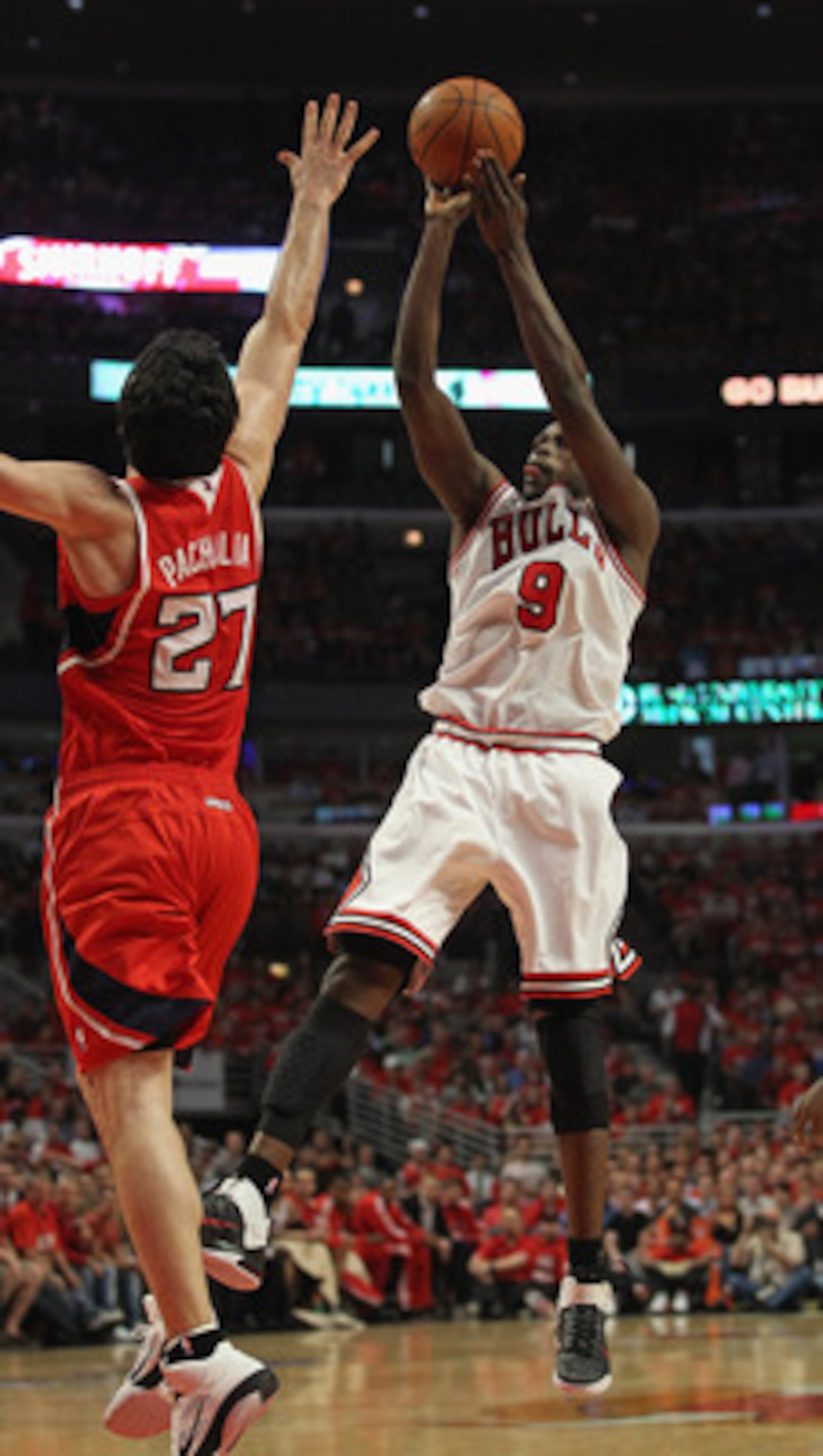 CHICAGO, IL - MAY 10: Loul Deng #9 of the Chicago Bulls puts up a shot against Zaza Pachulia #27 of the Atlanta Hawks in Game Five of the Eastern Conference Semifinals in the 2011 NBA Playoffs at the United Center on May 10, 2011 in Chicago, Illinois. The