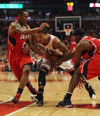 CHICAGO, IL - MAY 10: Derrick Rose #1 of the Chicago Bulls drives between Jeff Teague #0 (L) and Joe Johnson #2 of the Atlanta Hawks in Game Five of the Eastern Conference Semifinals in the 2011 NBA Playoffs at the United Center on May 10, 2011 in Chicago CHICAGO, IL - MAY 10: Derrick Rose #1 of the Chicago Bulls drives between Jeff Teague #0 (L) and Joe Johnson #2 of the Atlanta Hawks in Game Five of the Eastern Conference Semifinals in the 2011 NBA Playoffs at the United Center on May 10, 2011 in Chicago