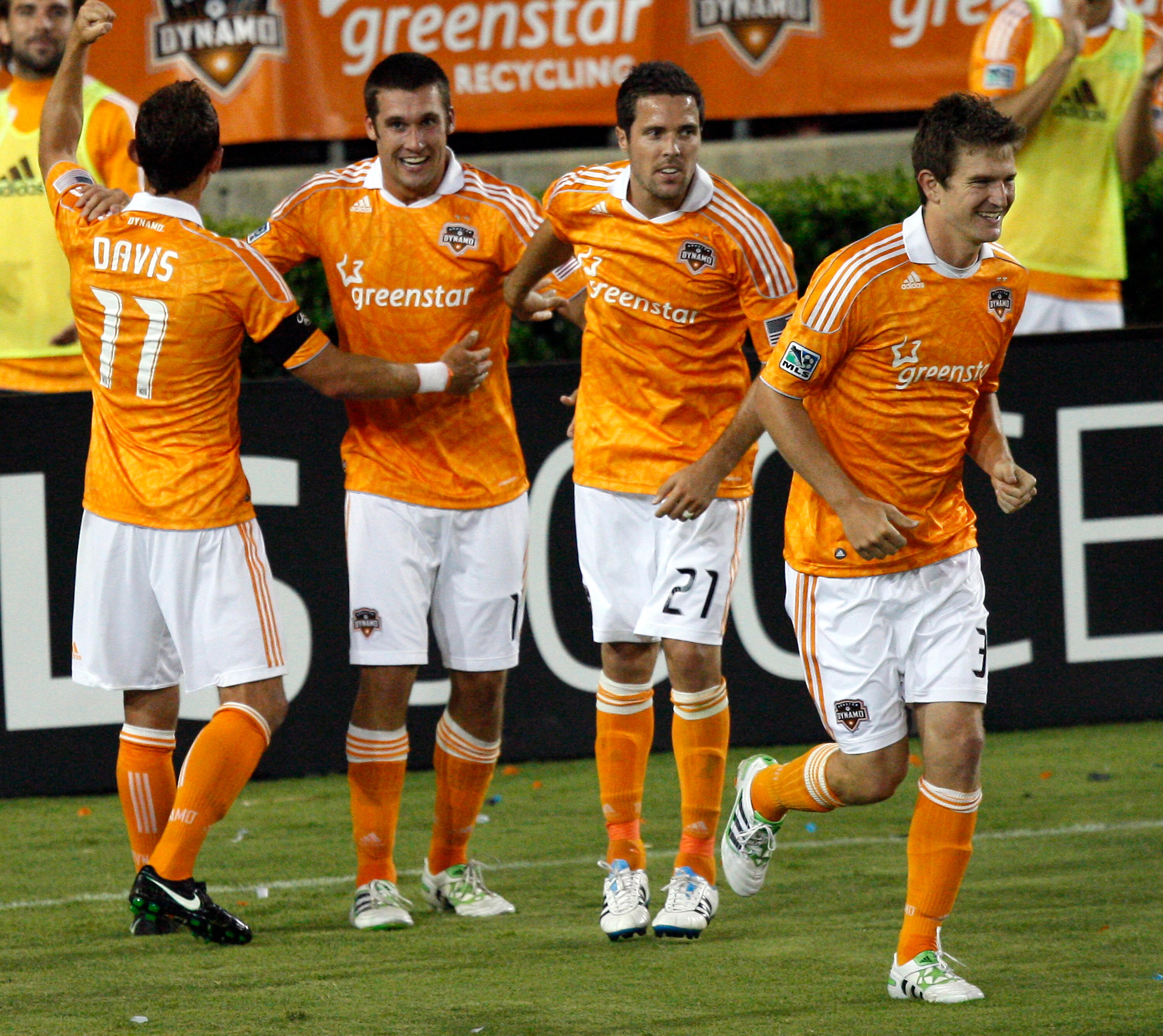 HOUSTON - APRIL 29:  Forward  Will Bruin #12, second from left, of the Houston Dynamo is congratulated by Brad Davis #11, Hunter Freeman #21 and Bobby Boswell #32 after scoring his third goal of the game in the second half against D.C. United at Robertson