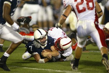UNIVERSITY PARK, PA - SEPTEMBER 14:  Zack Mills #7 of Penn State is tackled by Jerrell Pippens #31 of Nebraska during the NCAA football game against Penn State at Beaver Stadium in University Park, Pennsylvania on September 14, 2002. The Penn State Nittan