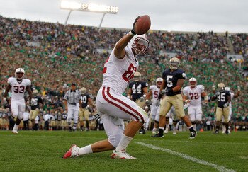 SOUTH BEND, IN - SEPTEMBER 25: Coby Fleener #82 of the Stanford Cardinal celebrates a touchdown catch against the Notre Dame Fighting Irish tries to defend at Notre Dame Stadium on September 25, 2010 in South Bend, Indiana. Standford defeated Notre Dame 3