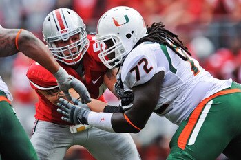 COLUMBUS, OH - SEPTEMBER 11:  John Simon #54 of the Ohio State Buckeyes is blocked by Brandon Washington #72 of the Miami Hurricanes at Ohio Stadium on September 11, 2010 in Columbus, Ohio.  (Photo by Jamie Sabau/Getty Images)