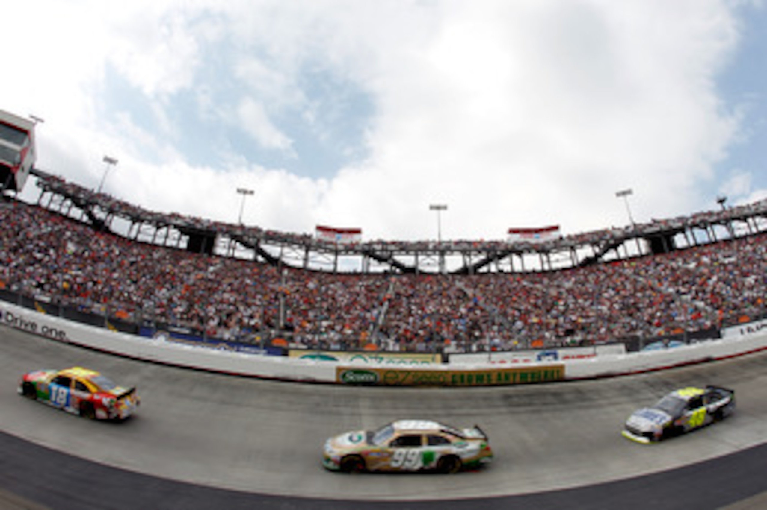 BRISTOL, TN - MARCH 20:  Kyle Busch, driver of the #18 M&M's Toyota, leads Carl Edwards, driver of the #99 Scotts EZ Seed Ford, and Jimmie Johnson, driver of the #48 Lowe's/Kobalt Tools Chevrolet, during the NASCAR Sprint Cup Series Jeff Byrd 500 Presente