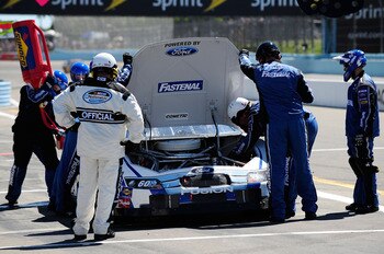 WATKINS GLEN, NY - AUGUST 07:  Crew members look over the #60 Fastenal Ford, driven by Carl Edwards (L), after having engine problems in the NASCAR Nationwide Series Zippo 200 at Watkins Glen International on August 7, 2010 in Watkins Glen, New York.  (Ph