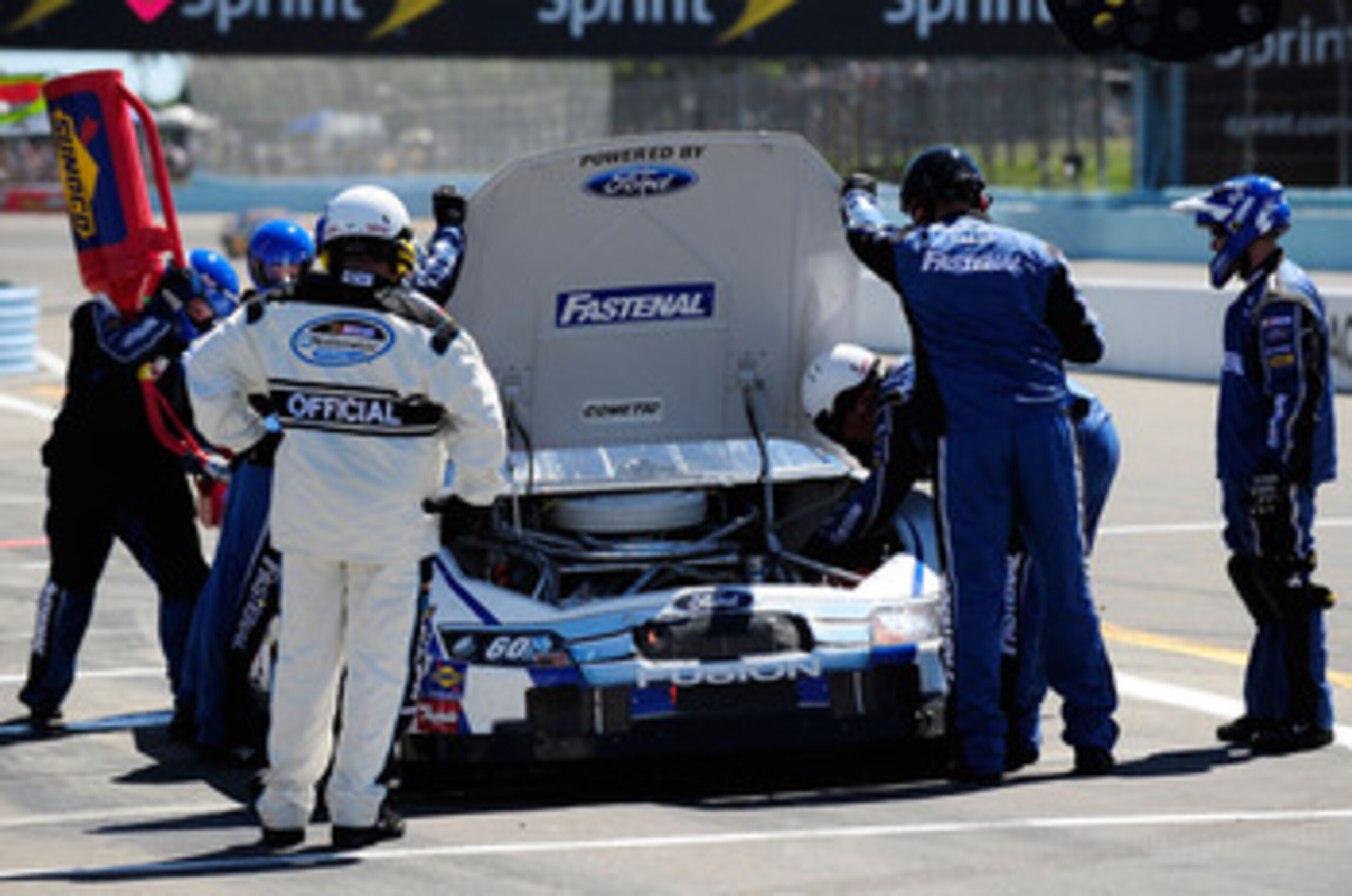 WATKINS GLEN, NY - AUGUST 07:  Crew members look over the #60 Fastenal Ford, driven by Carl Edwards (L), after having engine problems in the NASCAR Nationwide Series Zippo 200 at Watkins Glen International on August 7, 2010 in Watkins Glen, New York.  (Ph