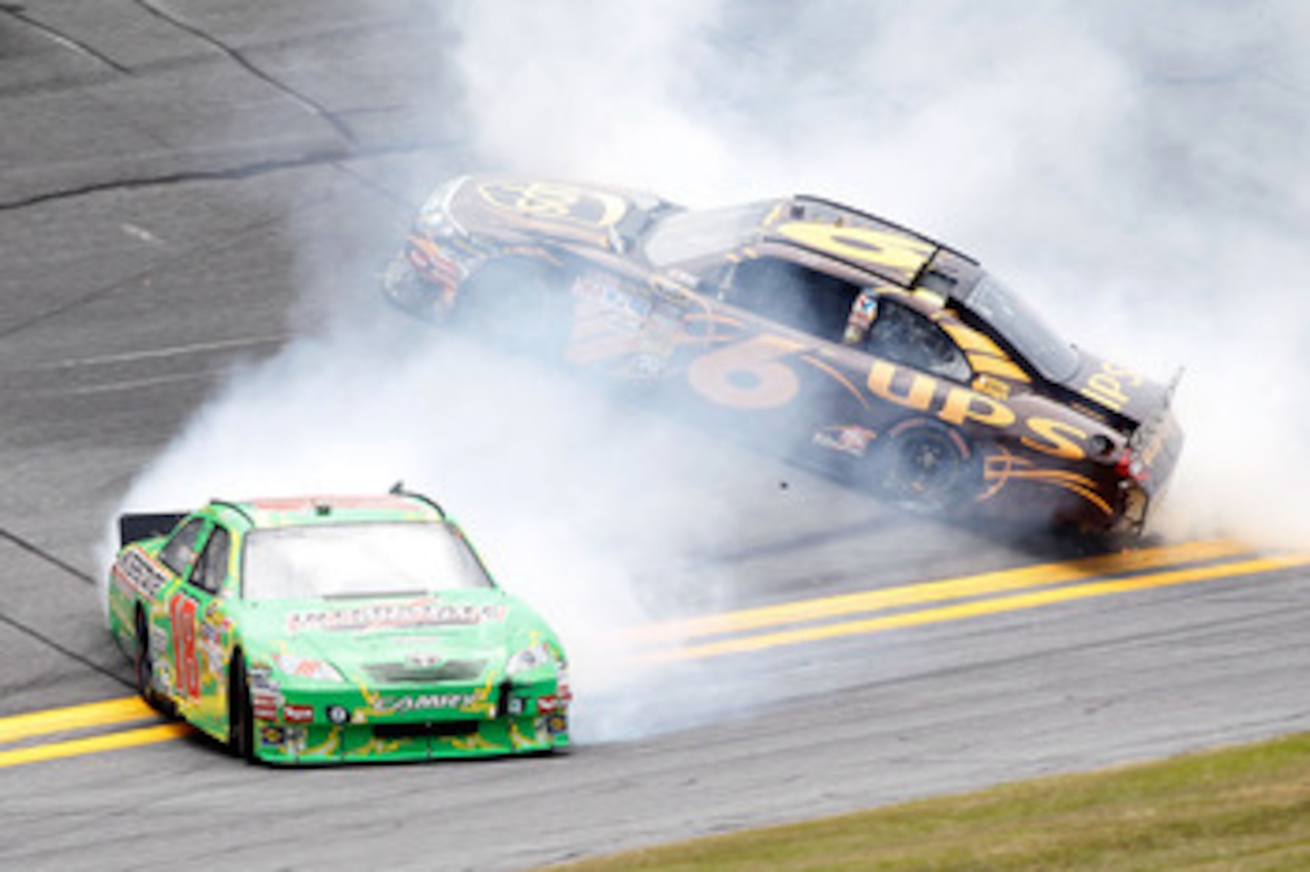 DAYTONA BEACH, FL - JULY 01:  Kyle Busch, driver of the #18 Interstate Batteries Toyota, and David Ragan, driver of the #6 UPS Ford, spin out of control after an incident in practice for the NASCAR Sprint Cup Series Coke Zero 400 at Daytona International 