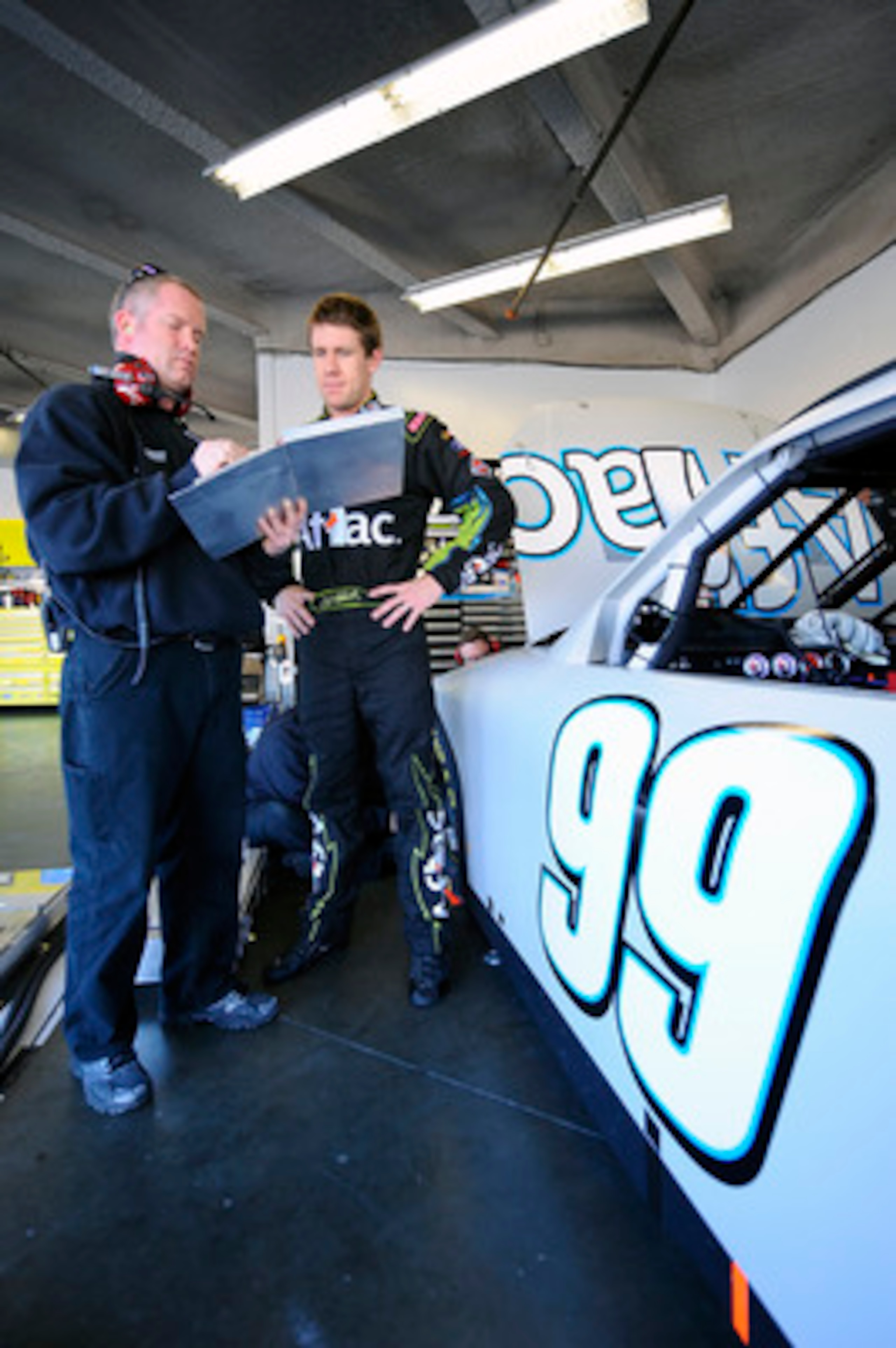 DAYTONA BEACH, FL - JANUARY 20:  Carl Edwards, driver of the #99 Aflac Ford, talks with his crew chief, Bob Osborne, during a test session at Daytona International Speedway on January 20, 2011 in Daytona Beach, Florida.  (Photo by Jared C. Tilton/Getty Im