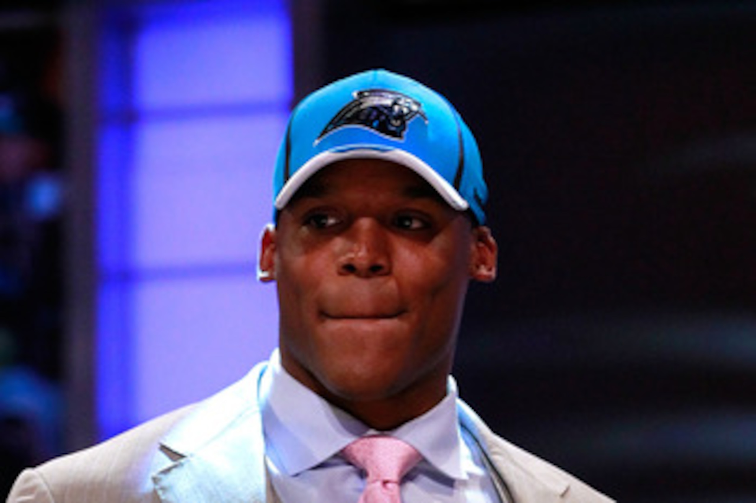 NEW YORK, NY - APRIL 28:  Cam Newton, #1 overall pick by the Carolina Panthers holds up a jersey on stage after he was picked during the 2011 NFL Draft at Radio City Music Hall on April 28, 2011 in New York City.  (Photo by Chris Trotman/Getty Images)