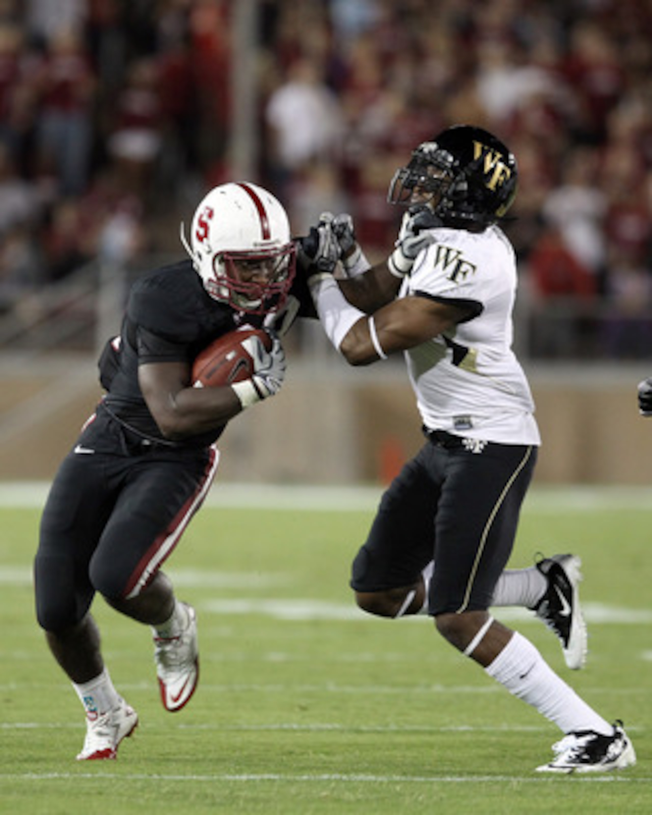 PALO ALTO, CA - SEPTEMBER 18:  Stepfan Taylor #33 of the Stanford Cardinal is tackled by Kenny Okoro #6 of the Wake Forest Demon Deacons at Stanford Stadium on September 18, 2010 in Palo Alto, California.  (Photo by Ezra Shaw/Getty Images)