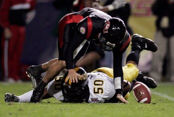 LAFAYETTE, LA - DECEMBER 20:  Quarterback Nick Noce #8 of Arkansas State fumbles the ball after being hit by Akeem Lockett #50 of Southern Miss during The New Orleans Bowl on December 20, 2005 at Cajun Field in Lafayette, Louisiana. Southern Miss defeated