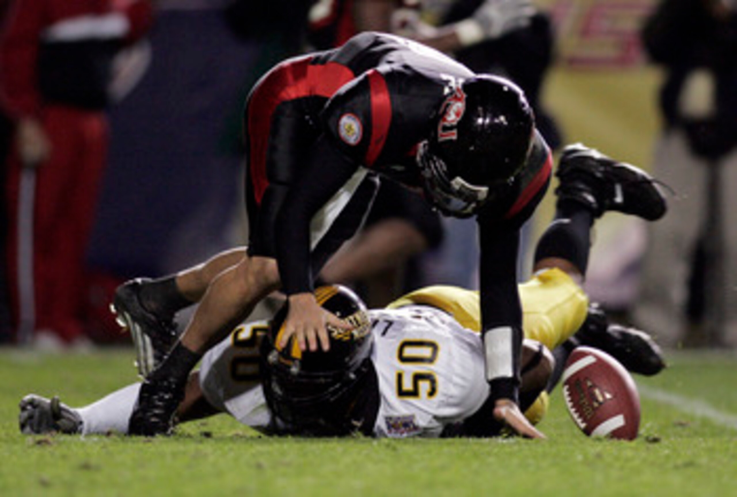 LAFAYETTE, LA - DECEMBER 20:  Quarterback Nick Noce #8 of Arkansas State fumbles the ball after being hit by Akeem Lockett #50 of Southern Miss during The New Orleans Bowl on December 20, 2005 at Cajun Field in Lafayette, Louisiana. Southern Miss defeated