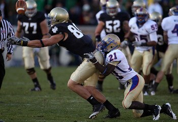SOUTH BEND, IN - OCTOBER 30: Tyler Eifert #80 of the Notre Dame Fighting Irish drops a pass as he is hit by John Flanders #21 of the Tulsa Golden Hurricane at Notre Dame Stadium on October 30, 2010 in South Bend, Indiana. Tulsa defeated Notre Dame 28-27. 