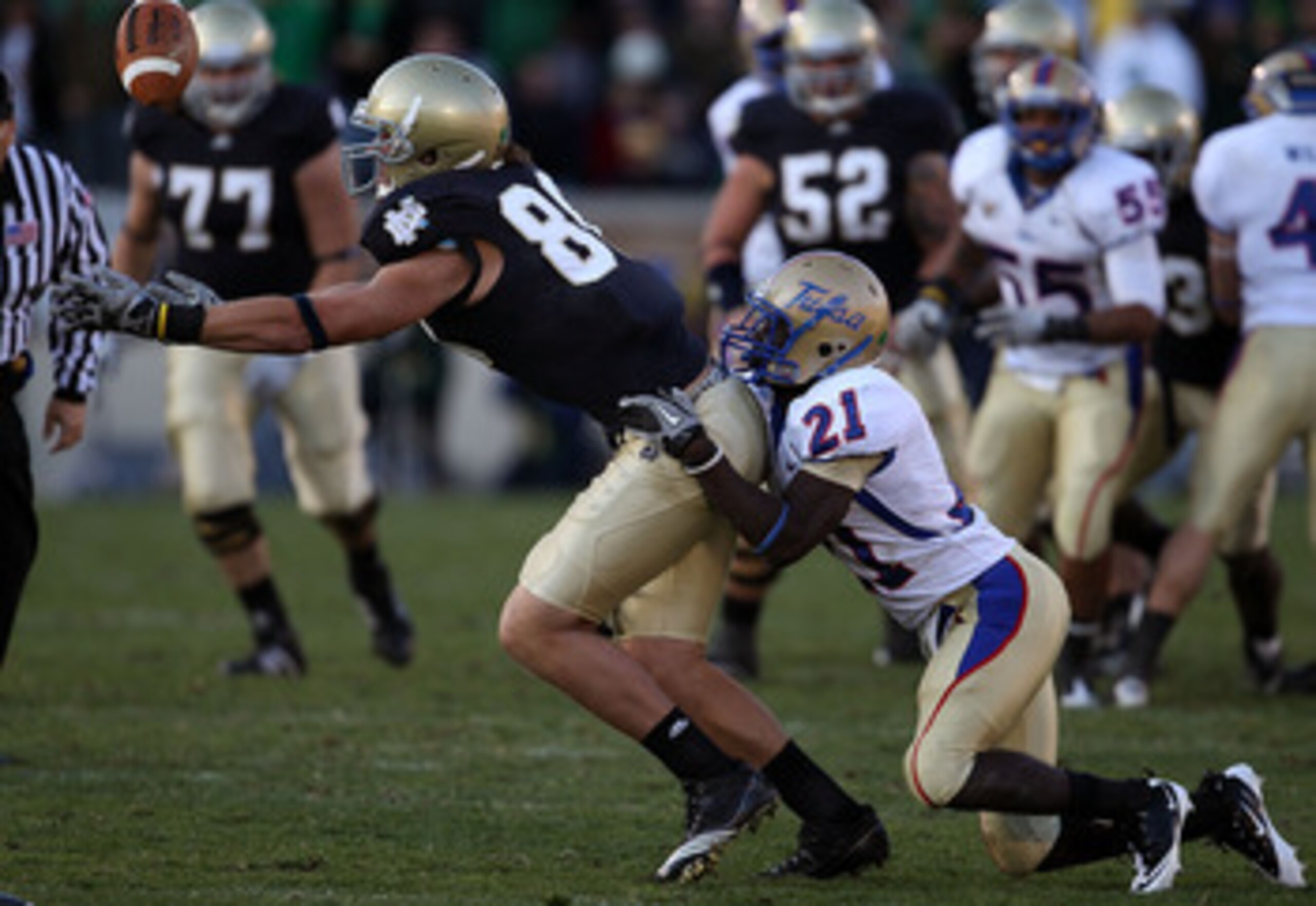 SOUTH BEND, IN - OCTOBER 30: Tyler Eifert #80 of the Notre Dame Fighting Irish drops a pass as he is hit by John Flanders #21 of the Tulsa Golden Hurricane at Notre Dame Stadium on October 30, 2010 in South Bend, Indiana. Tulsa defeated Notre Dame 28-27. 