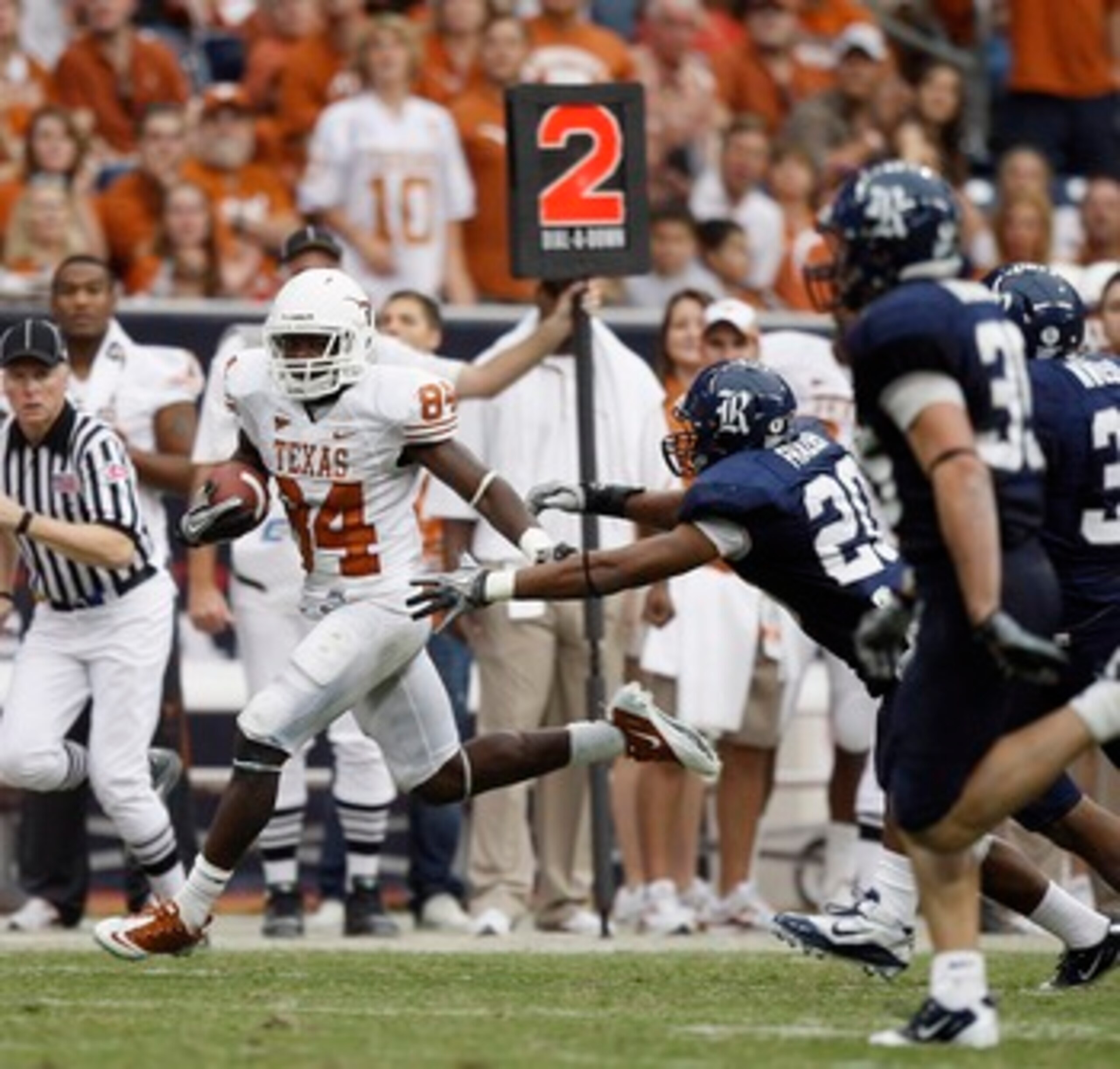 HOUSTON - SEPTEMBER 04:  Wide receiver mArquise Goodwin #84 of the Texas Longhorns runs past safety Corey Frazier #20 of the Rice Owls at Reliant Stadium on September 4, 2010 in Houston, Texas.  (Photo by Bob Levey/Getty Images)