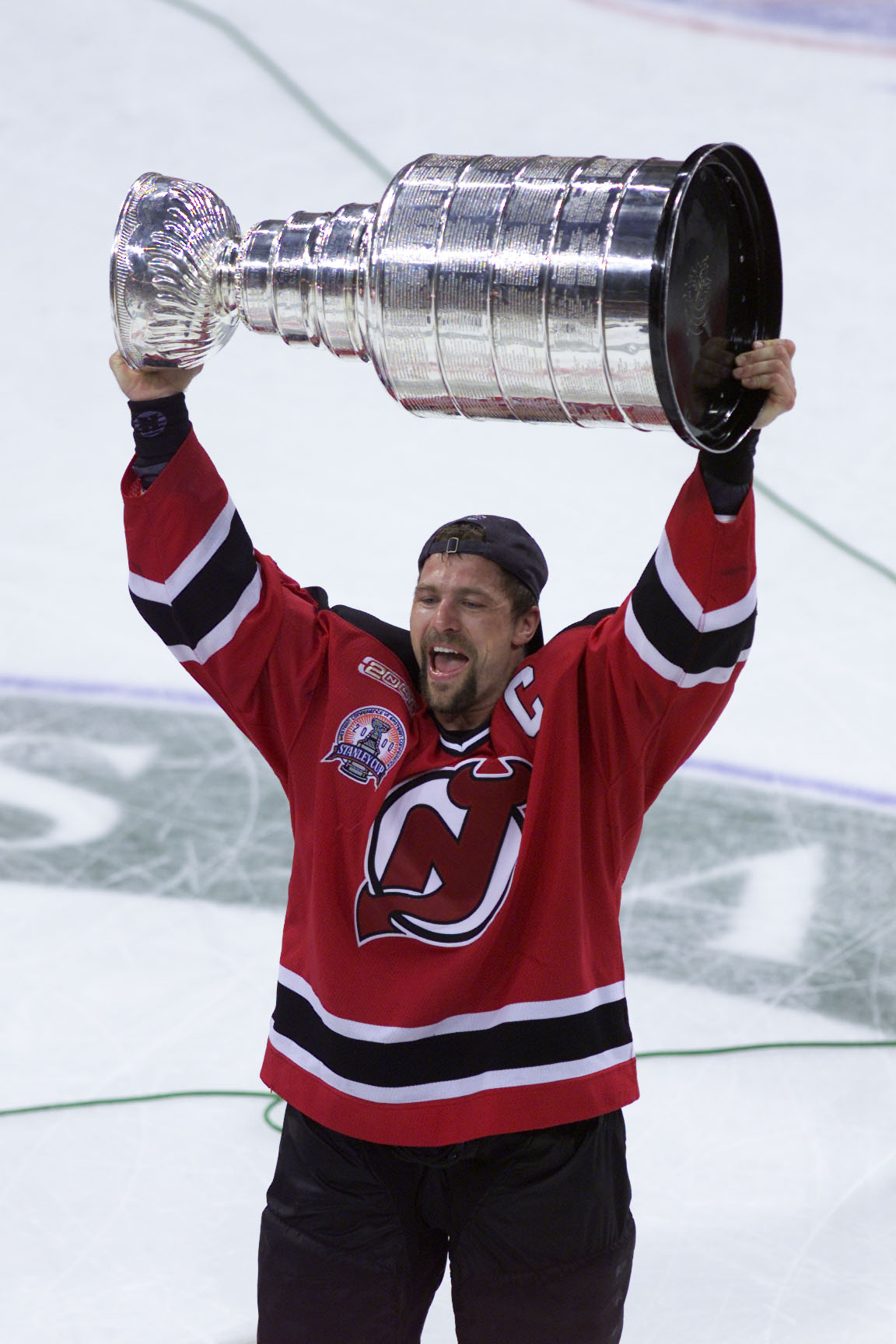 10 Jun 2000:  Scott Stevens #4 of the New Jersey Devils hoists the Stanley Cup trophy after winning Game 6 of the NHL Stanley Cup finals over the Dallas Stars at Reunion Arena in Dallas, Texas. The Devils won 2-1 in the second overtime period. DIGITAL IMA
