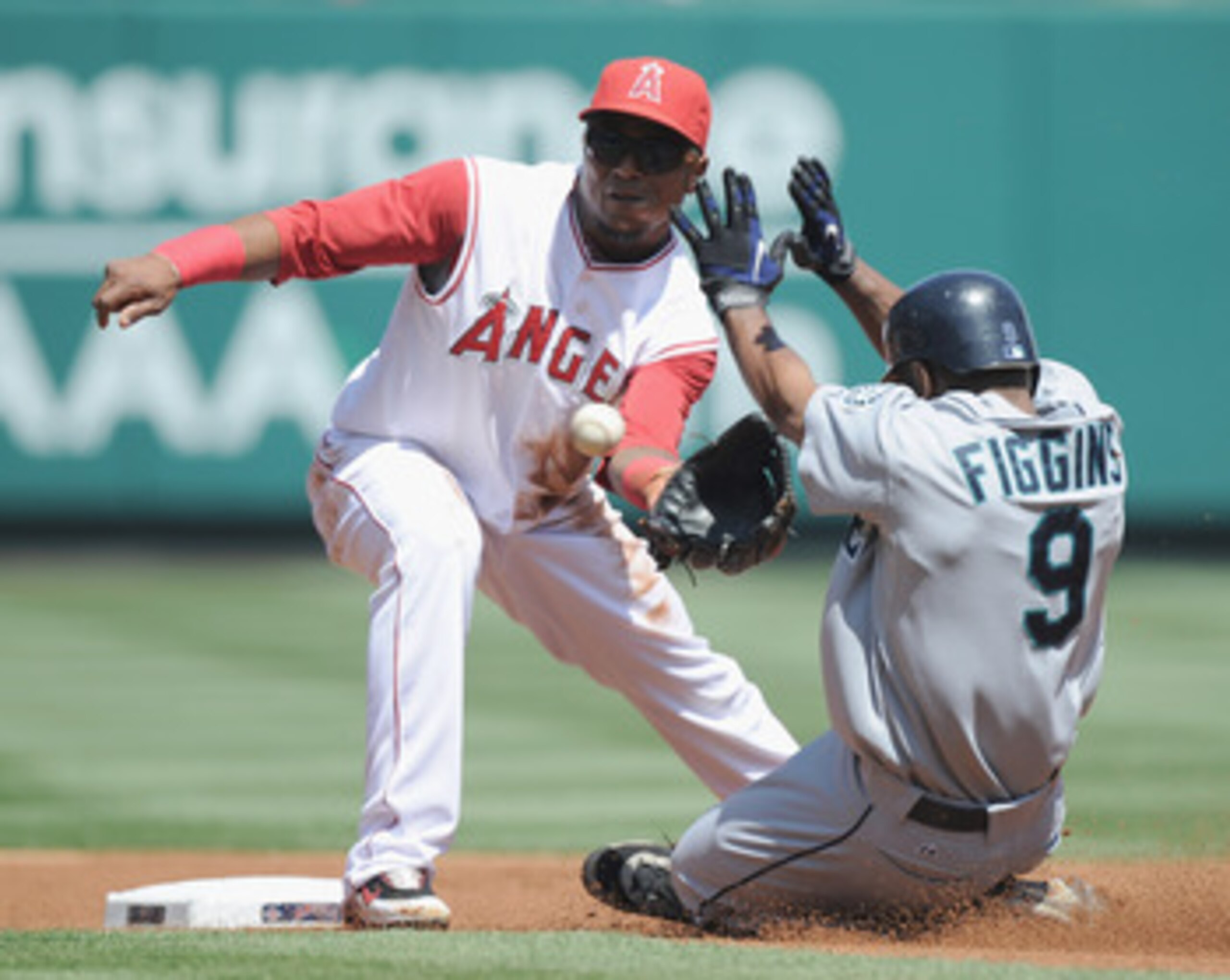 ANAHEIM, CA - SEPTEMBER 12:  Erick Aybar #2 of the Los Angeles Angels of Anaheim takes a throw at second base as Chone Figgins #9 of the Seattle Mariners is caught stealing during the first inning at Angel Stadium on September 12, 2010 in Anaheim, Califor