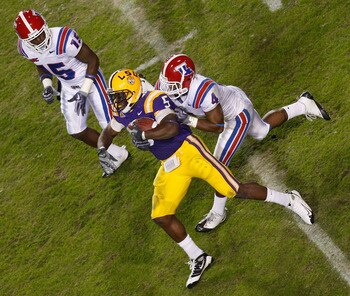 BATON ROUGE, LA - NOVEMBER 14:  Keiland Williams #5 of the LSU Tigers is tackled by Tank Calais #4 of the Louisiana Tech Bulldogs at Tiger Stadium on November 14, 2009 in Baton Rouge, Louisiana.  The Tigers defeated the Bulldogs 24-16.  (Photo by Chris Gr