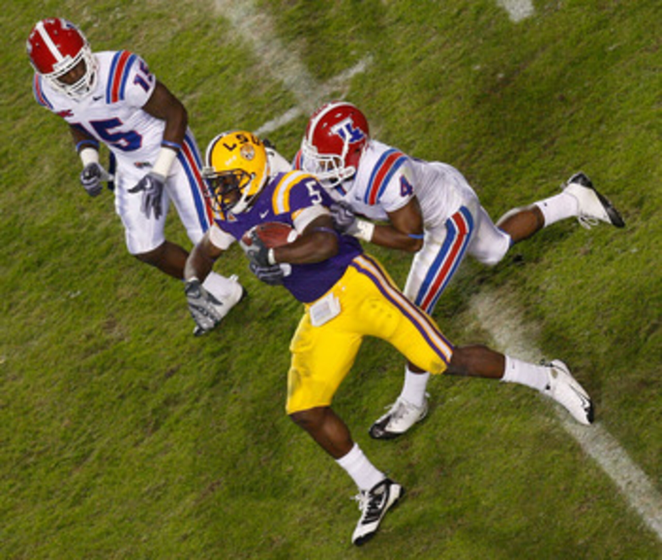 BATON ROUGE, LA - NOVEMBER 14:  Keiland Williams #5 of the LSU Tigers is tackled by Tank Calais #4 of the Louisiana Tech Bulldogs at Tiger Stadium on November 14, 2009 in Baton Rouge, Louisiana.  The Tigers defeated the Bulldogs 24-16.  (Photo by Chris Gr