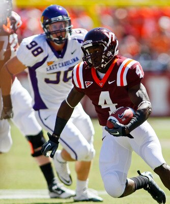 BLACKSBURG, VA - SEPTEMBER 18: Running back David Wilson #4 of the Virginia Tech Hokies runs with the ball as defensive tackle Matt Milner #98 of the East Carolina Pirates chases at Lane Stadium on September 18, 2010 in Blacksburg, Virginia.  (Photo by Ge